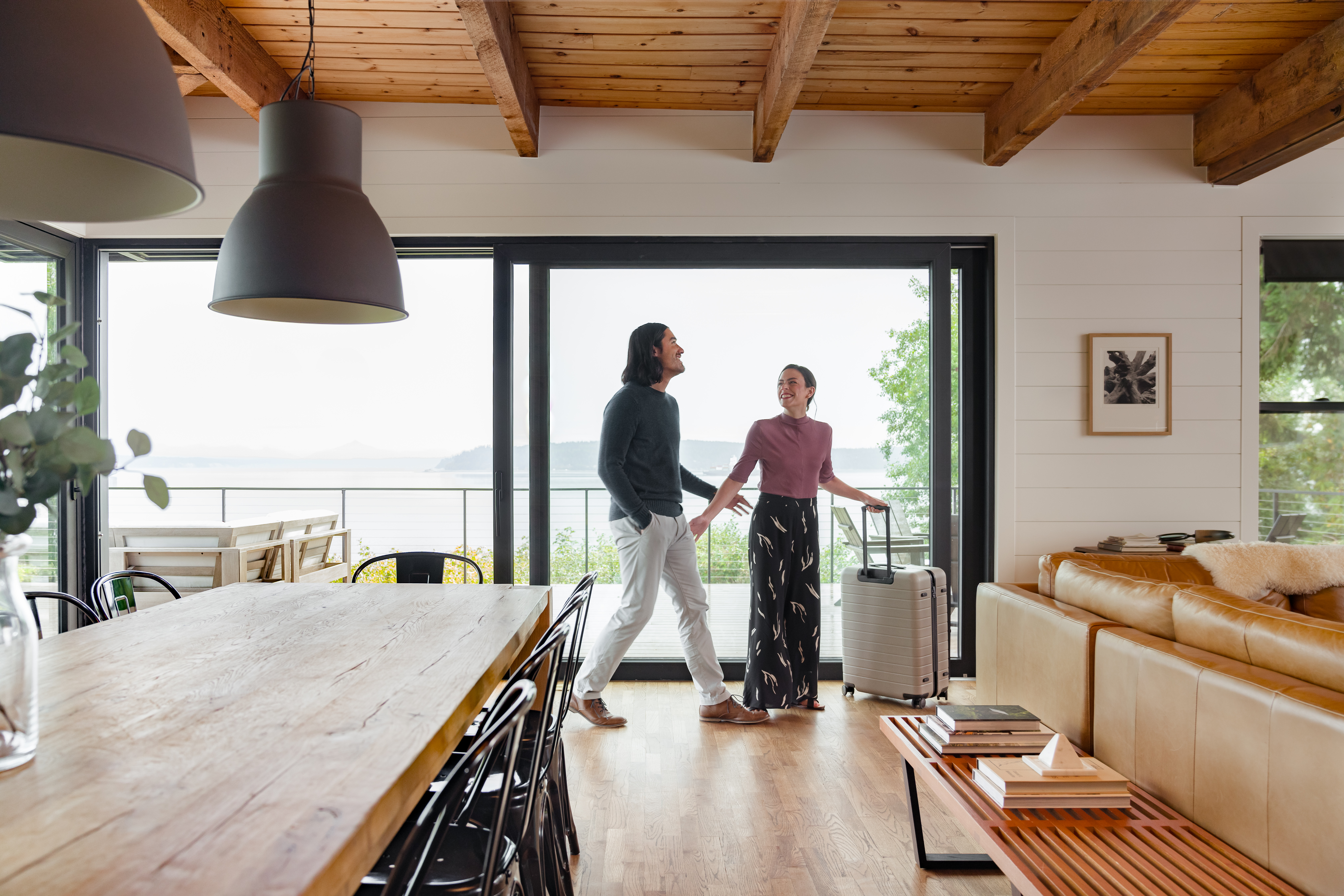 A couple exploring the living room area after arriving at their vacation home