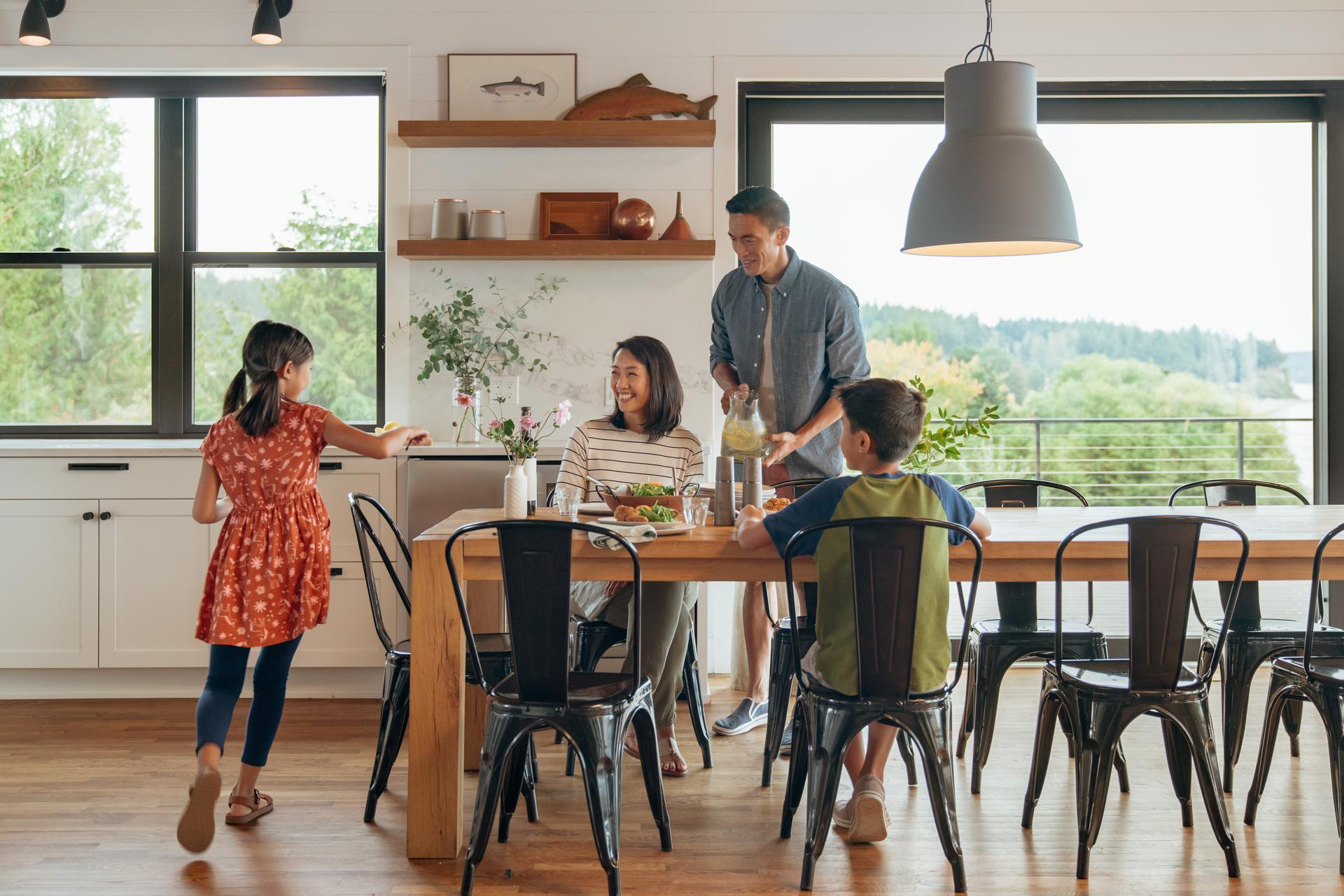 family with 2 kids eating dinner at their vacation home