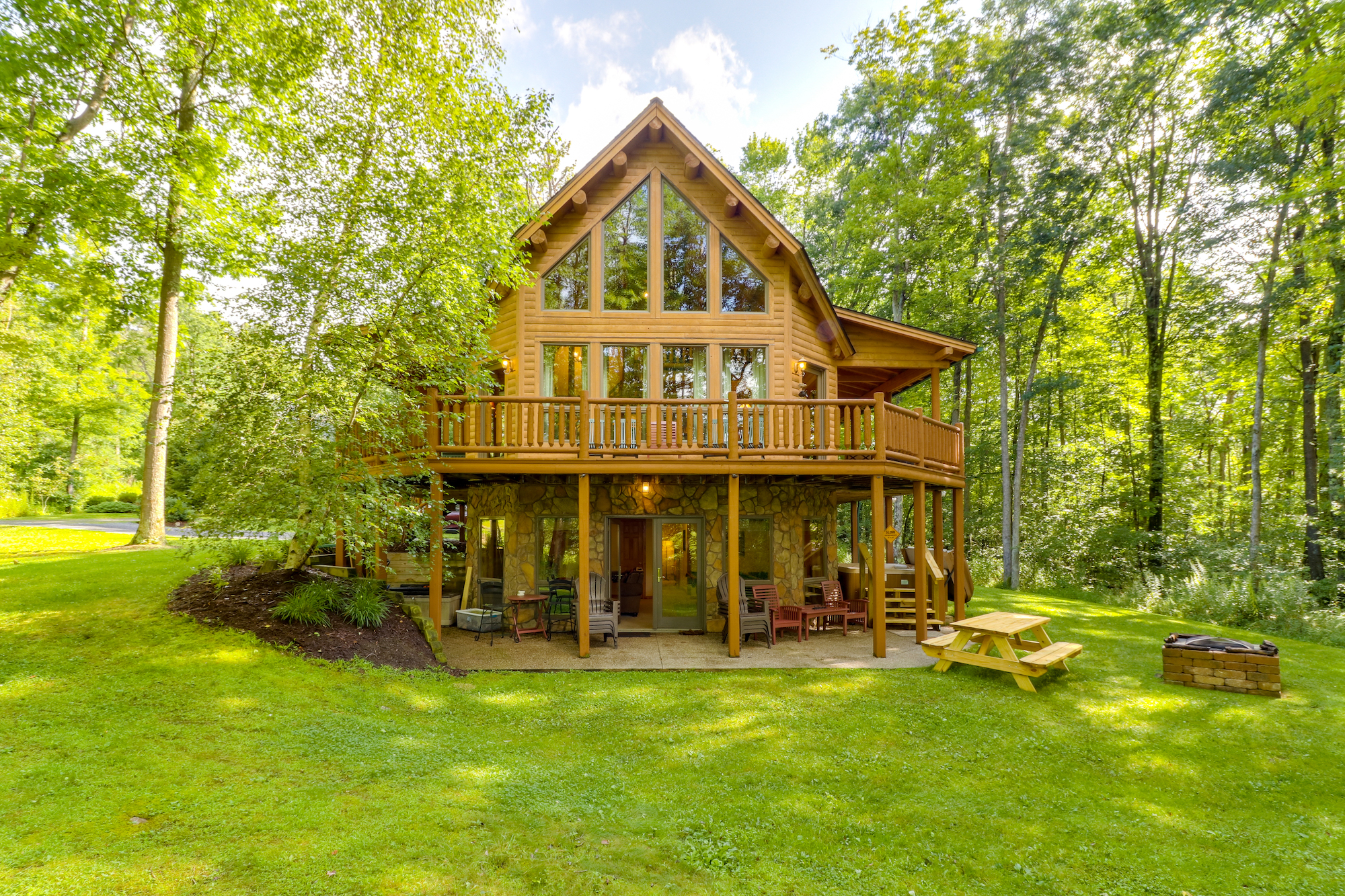 Wooden cabin with a wrap around deck and outdoor fire pit in Deep Creek Lake, MD