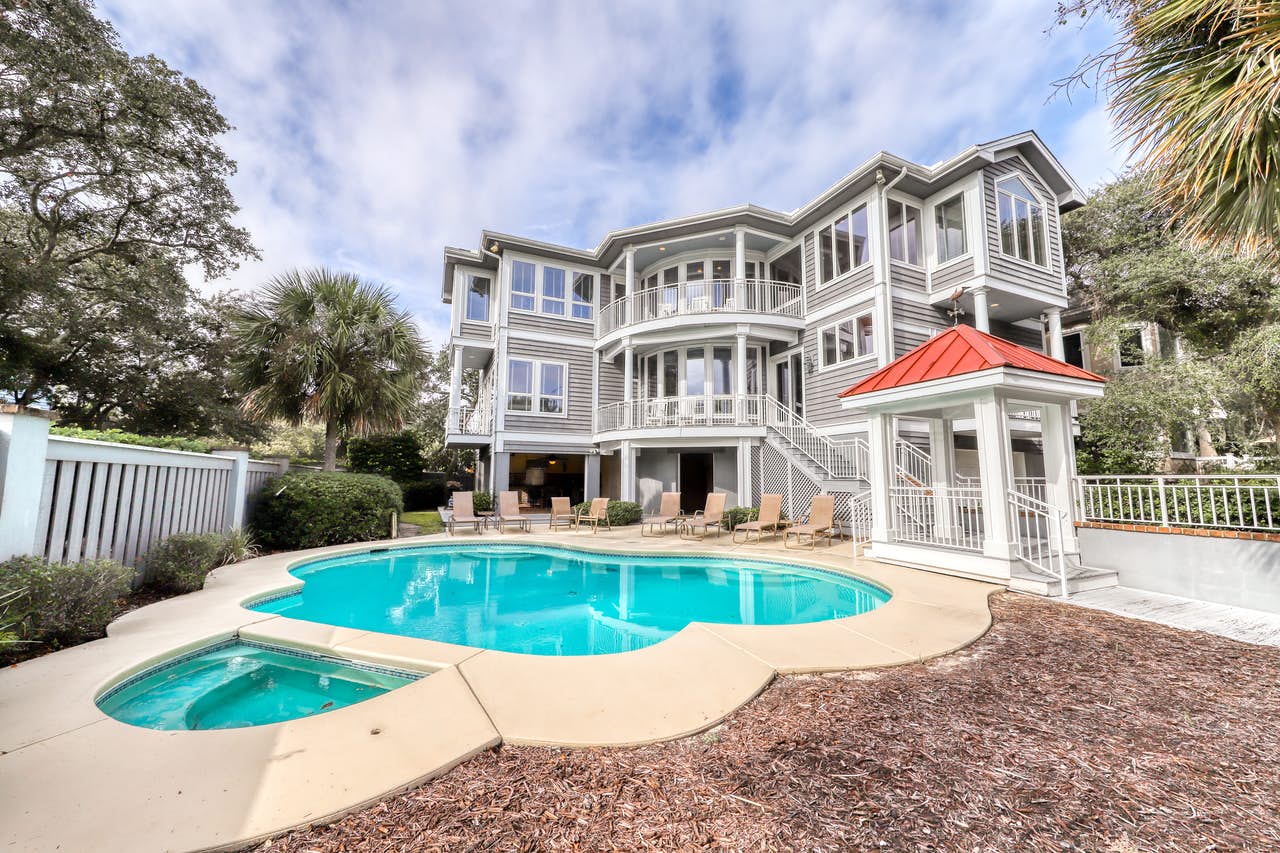 Three story vacation home rental in Hilton Head, SC with an outdoor hot tub and pool.