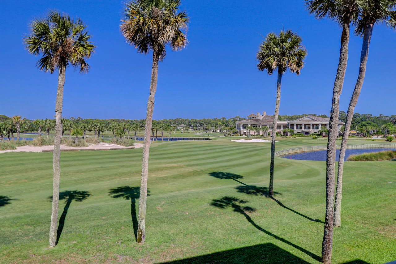 A golf course with palm trees and small ponds in Hilton Head, SC.