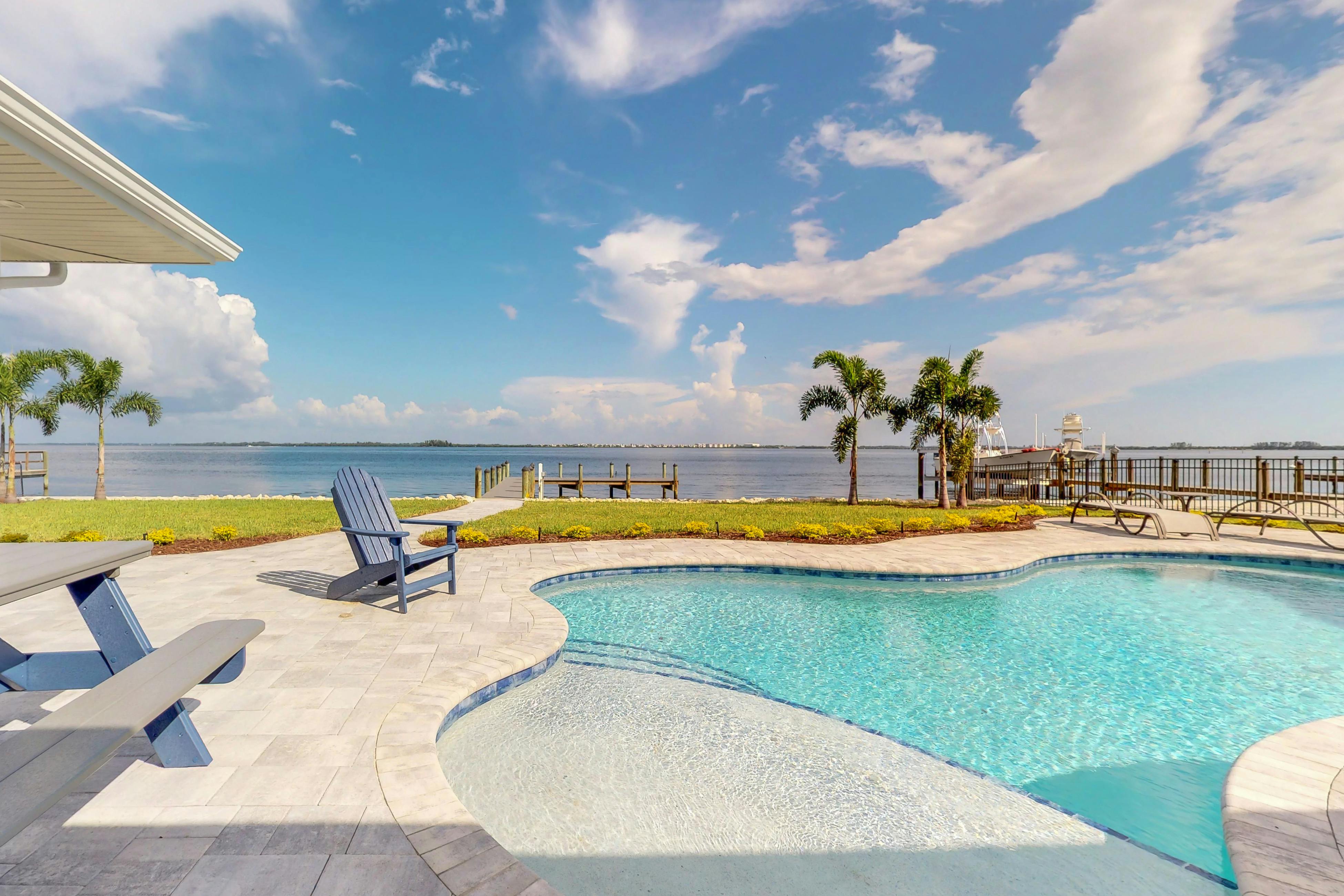 The pool and private dock overlooking the bay at a vacation rental in Holmes Beach, Florida.