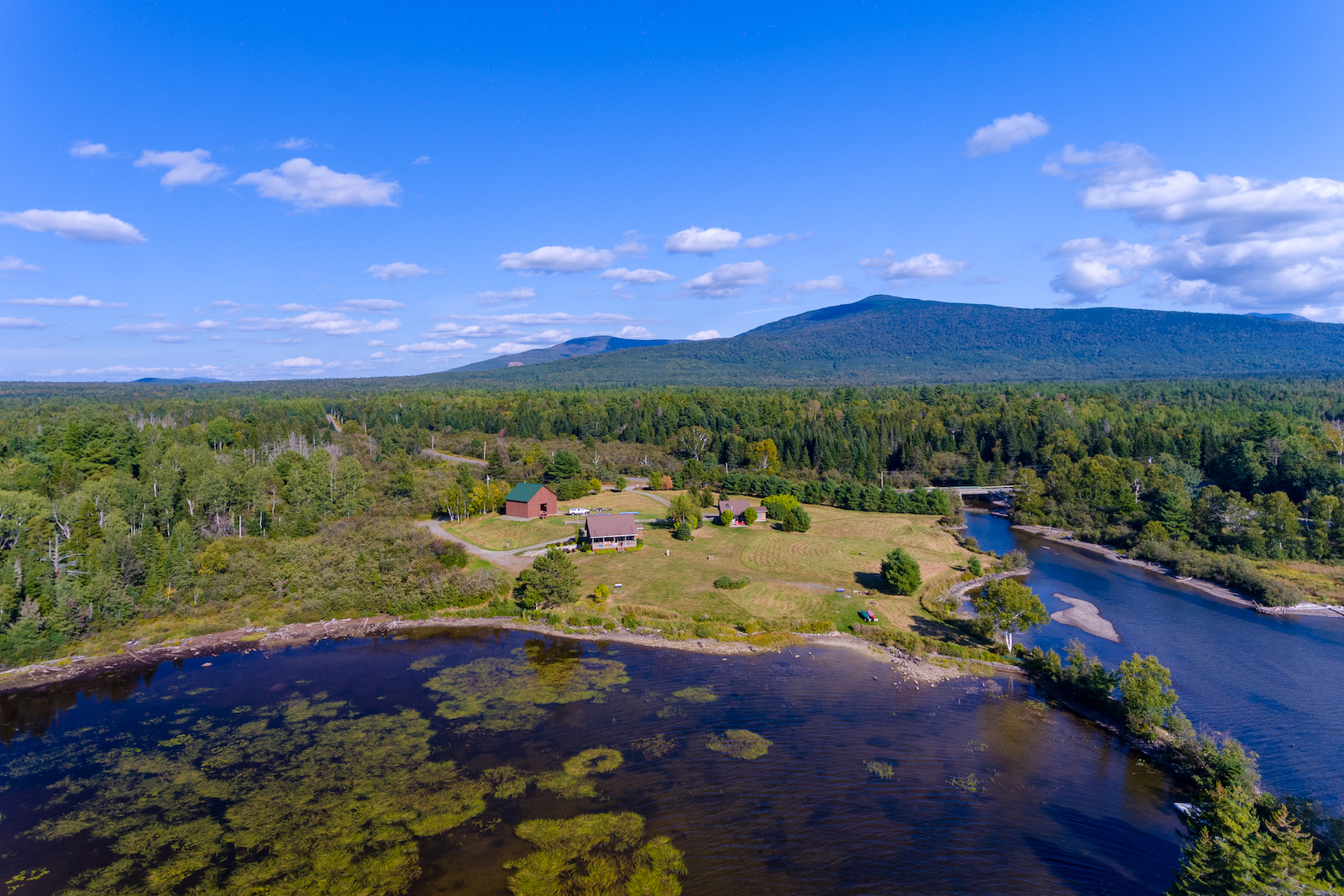 Drone shot overlooking Lily Bay and a vacation rental on the water in Maine.