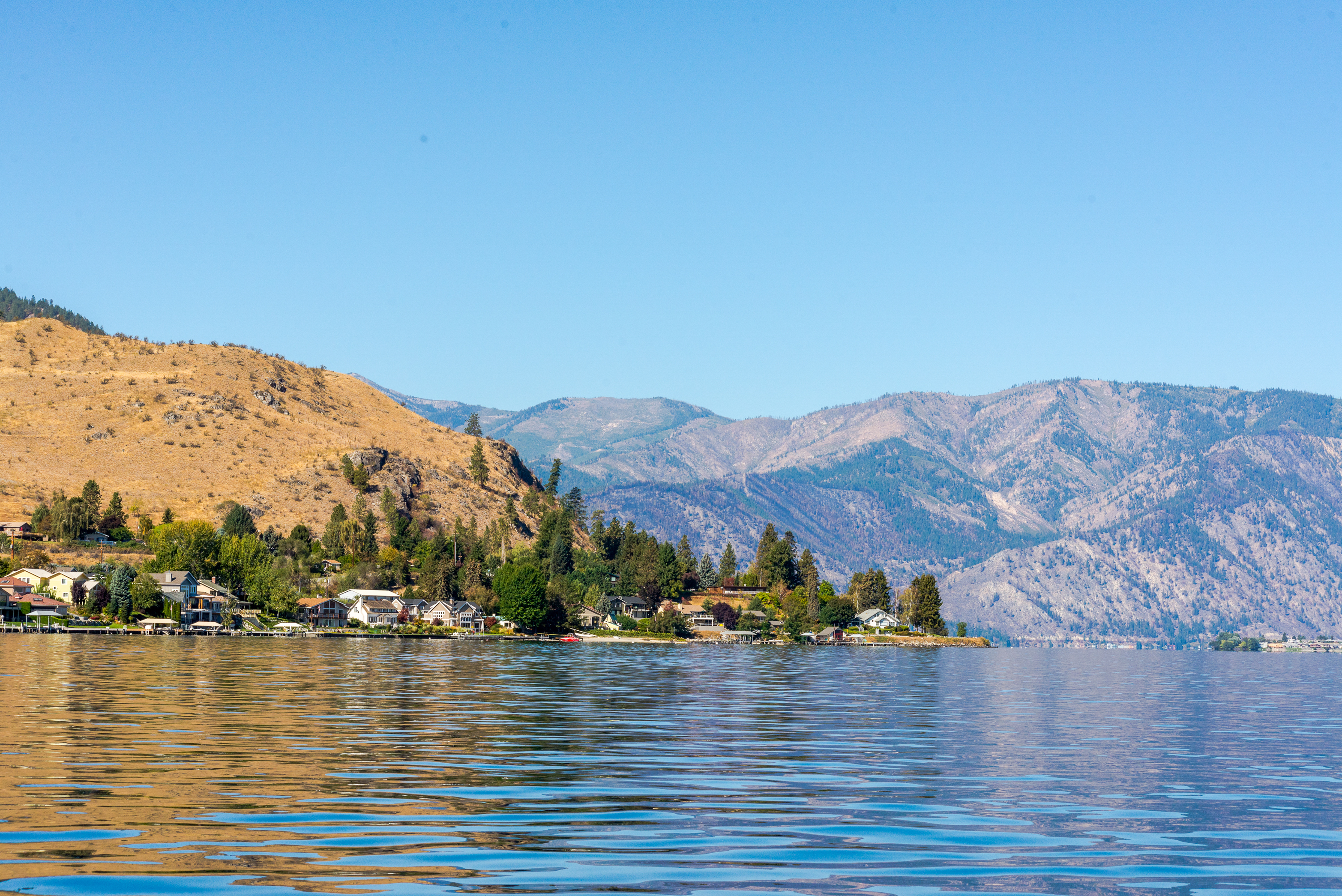 View of Lake Chelan with boats in the water at night.
