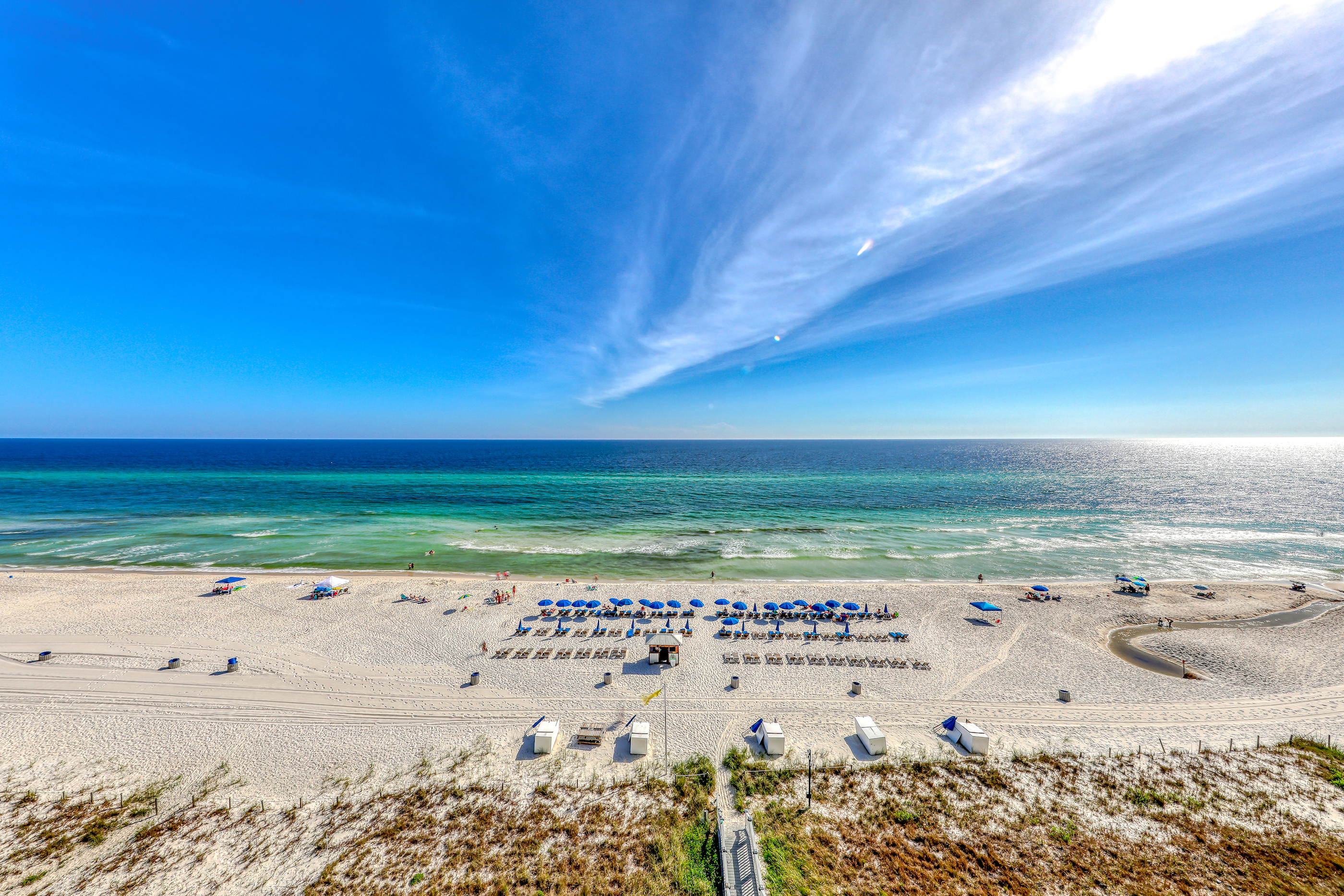 panama city beach filled with lounge chairs on a sunny day