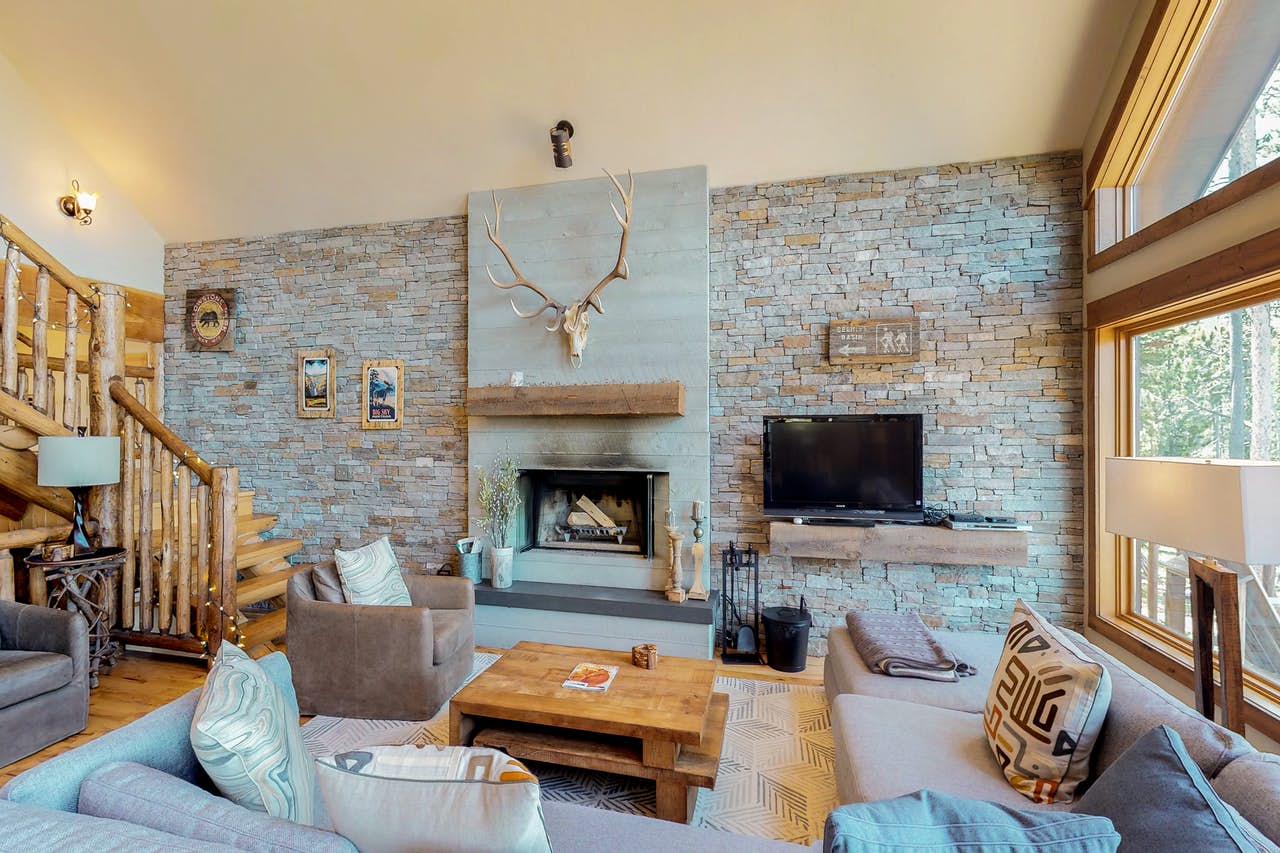 wood burning fireplace with a stag head mounted above in Big Sky, MT vacation home