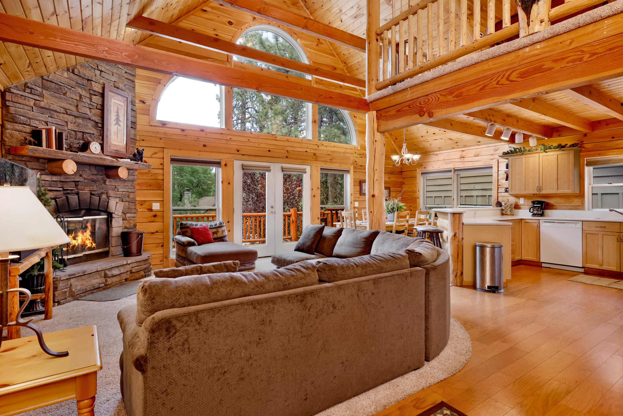 inside a cabin with a cozy interior and large windows