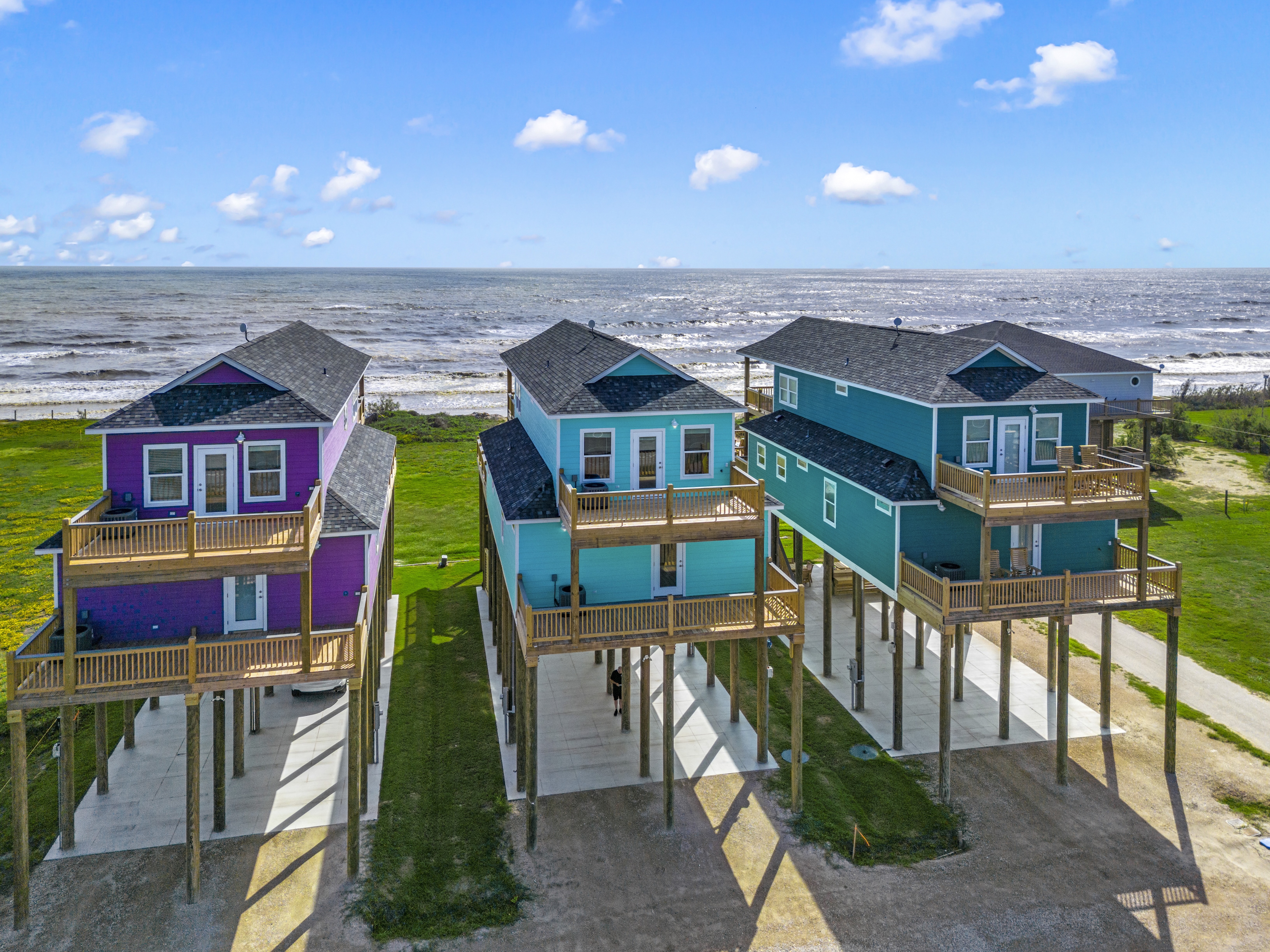 three colorful beachfront homes on the texas coast