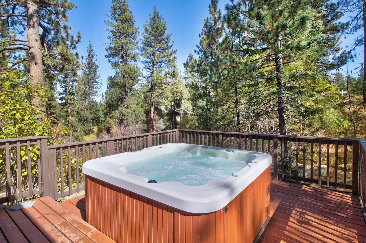 An outdoor hot tub in the back porch of a vacation home in Big Bear, CA.