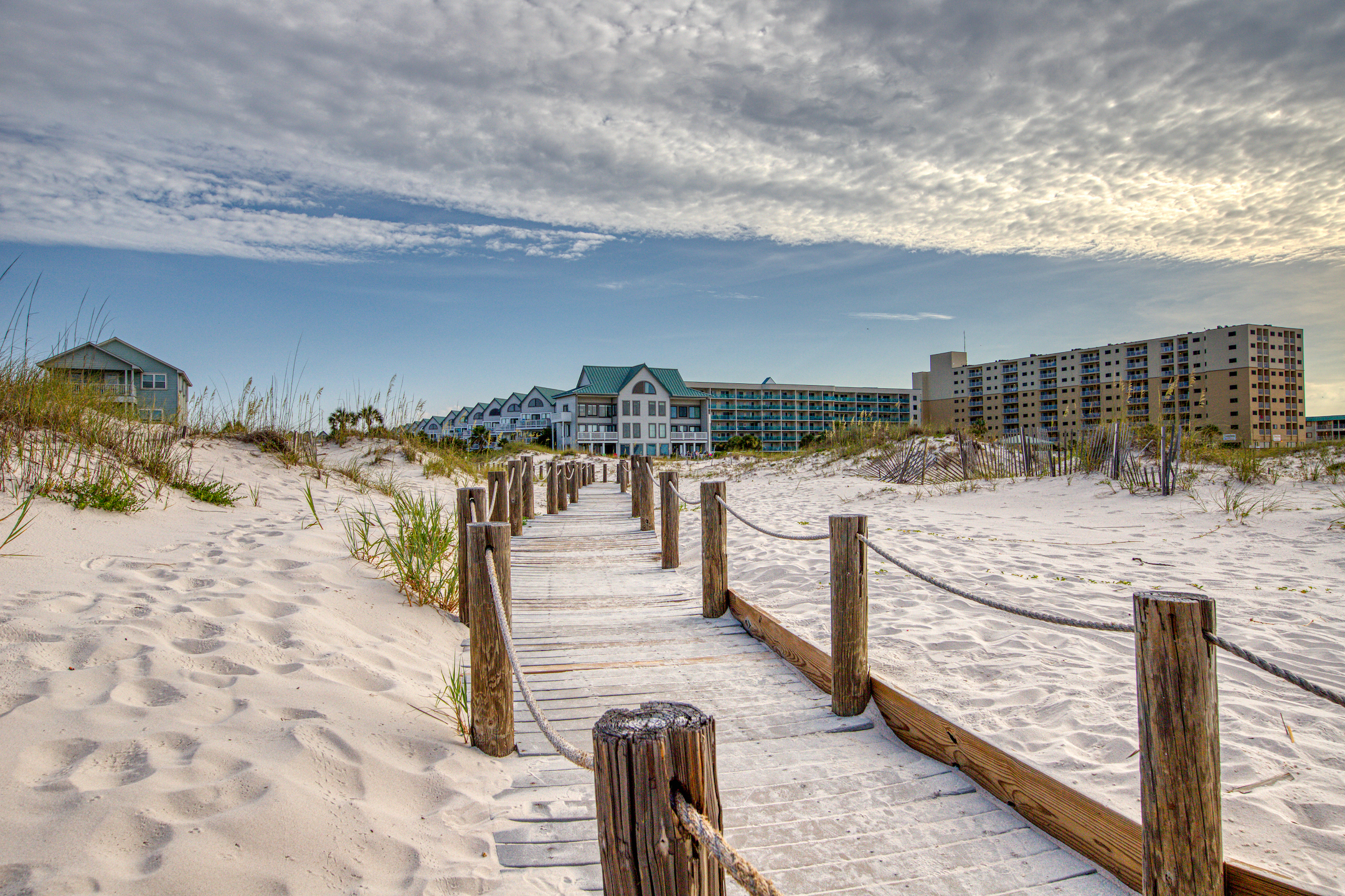 Wooden path over sand leads to the beach in Gulf Shores