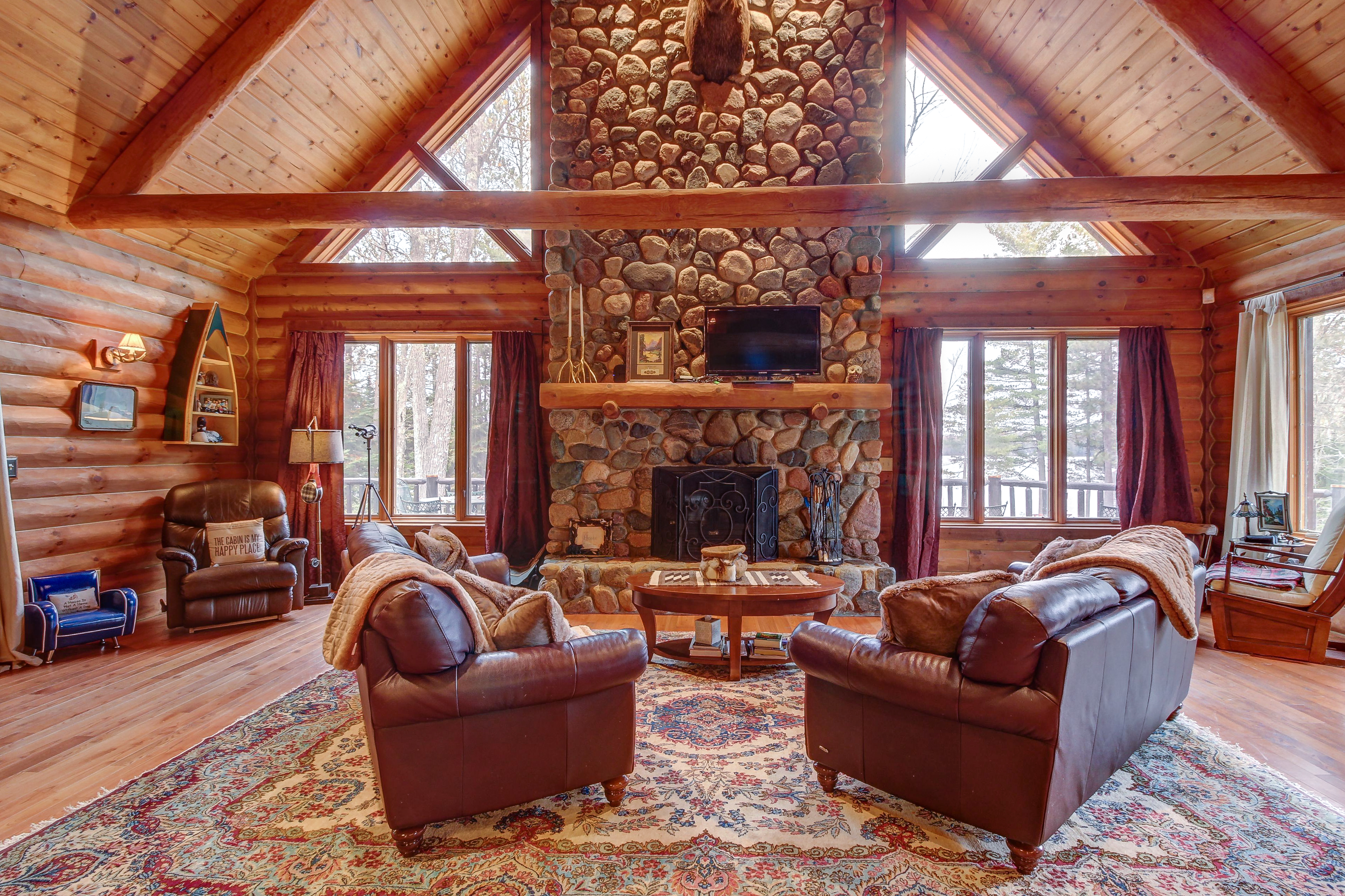 Rustic wooden style living room with a stone fire place in Three Lakes, WI