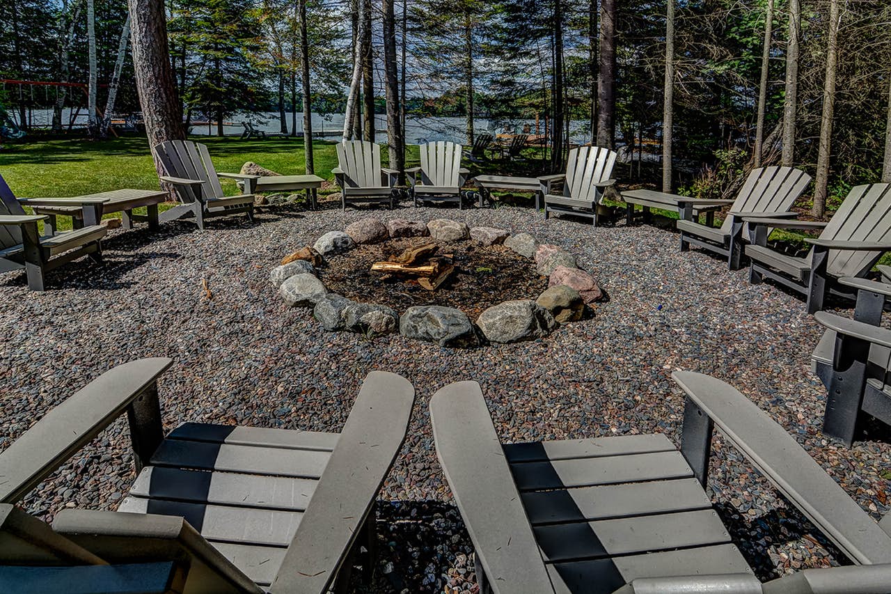 over 10 adirondack chairs sit around a fire pit in Eagle River, WI