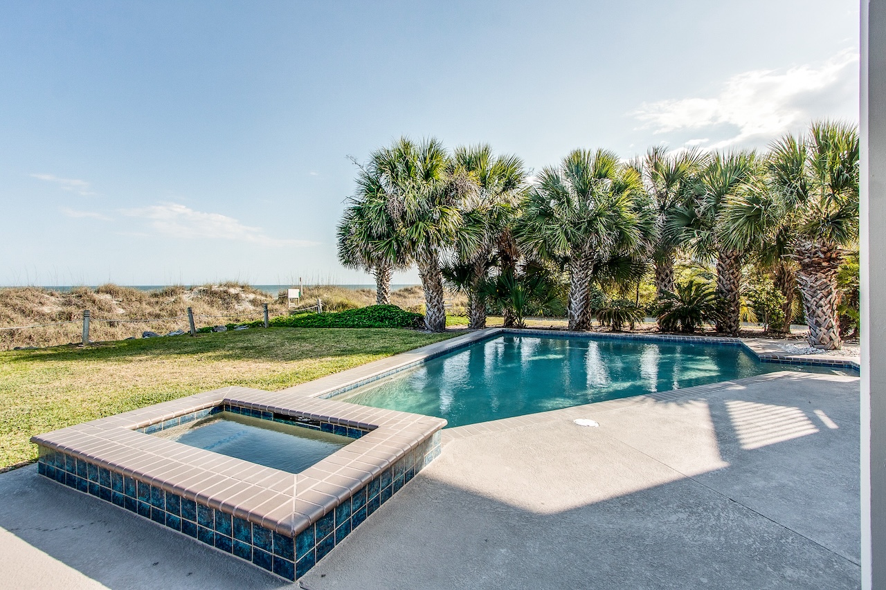The pool area overlooking the beach at a hilton head island vacation rental.