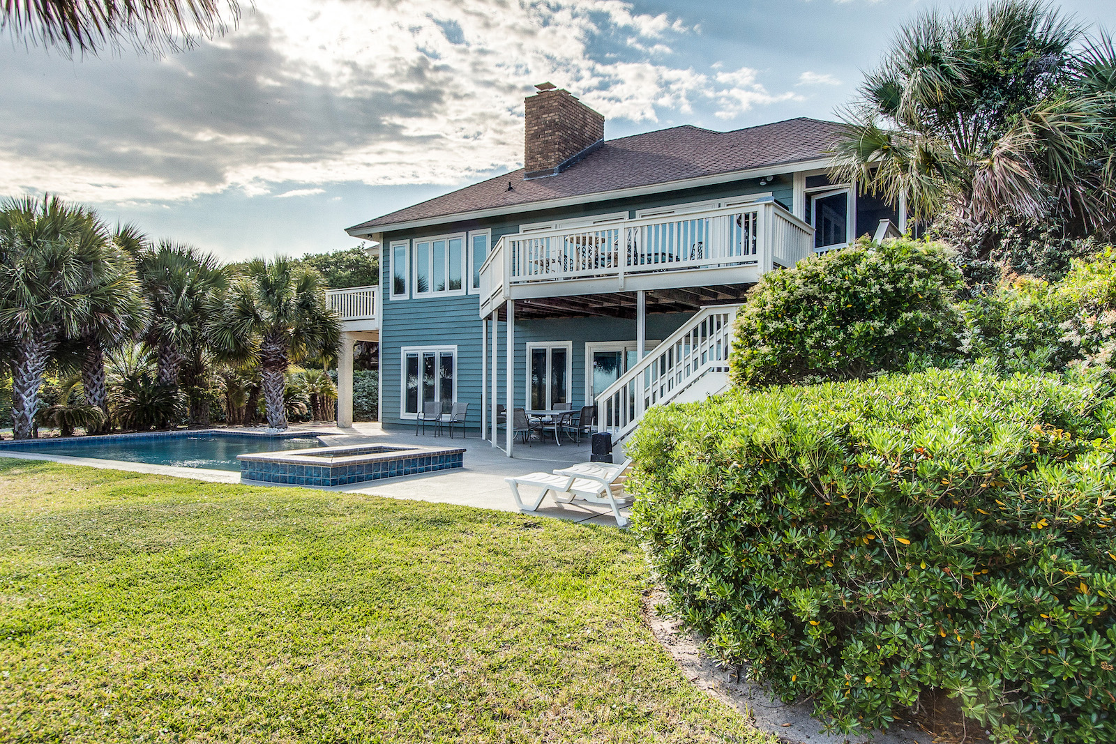 The backyard of a vacation rental in Hilton Head, SC with a pool.