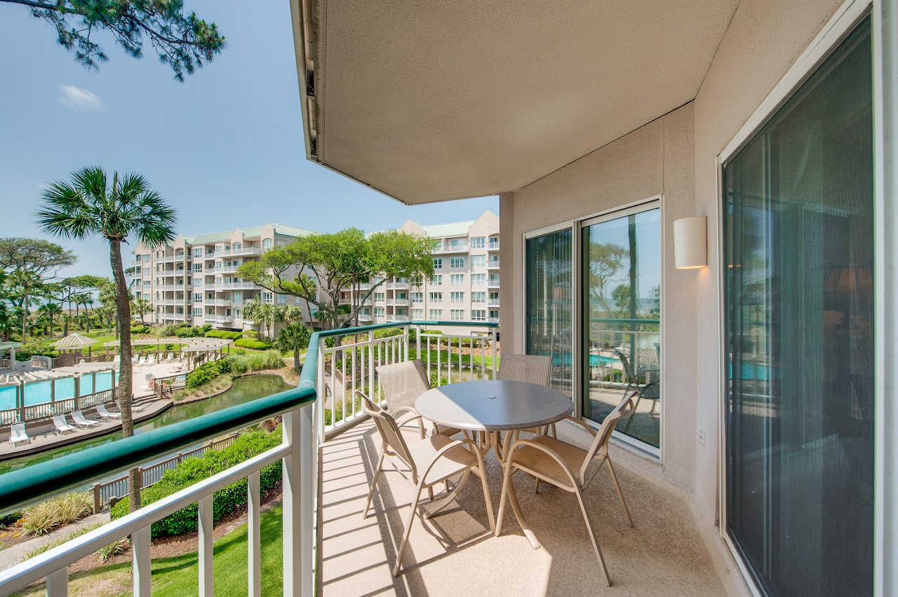 The patio area of a condo rental overlooking the resort pool at a rental in Hilton Head.
