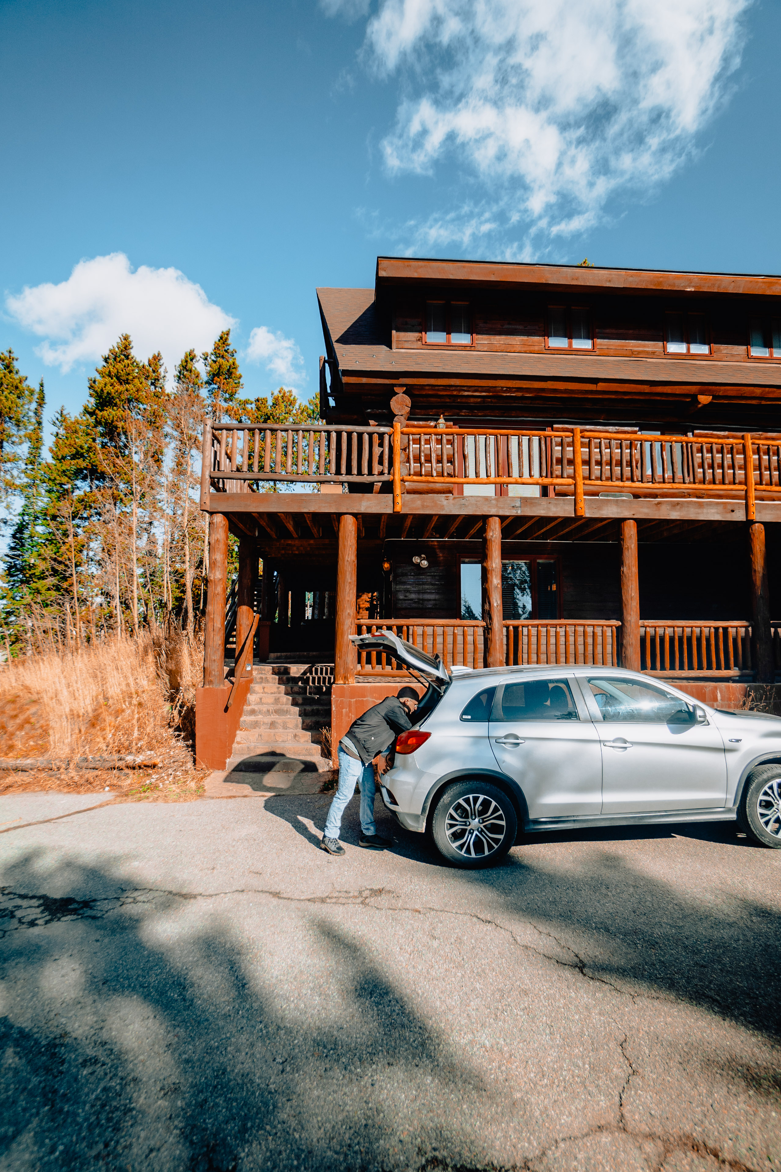man unloading his trunk after he arrived at his vacation rental