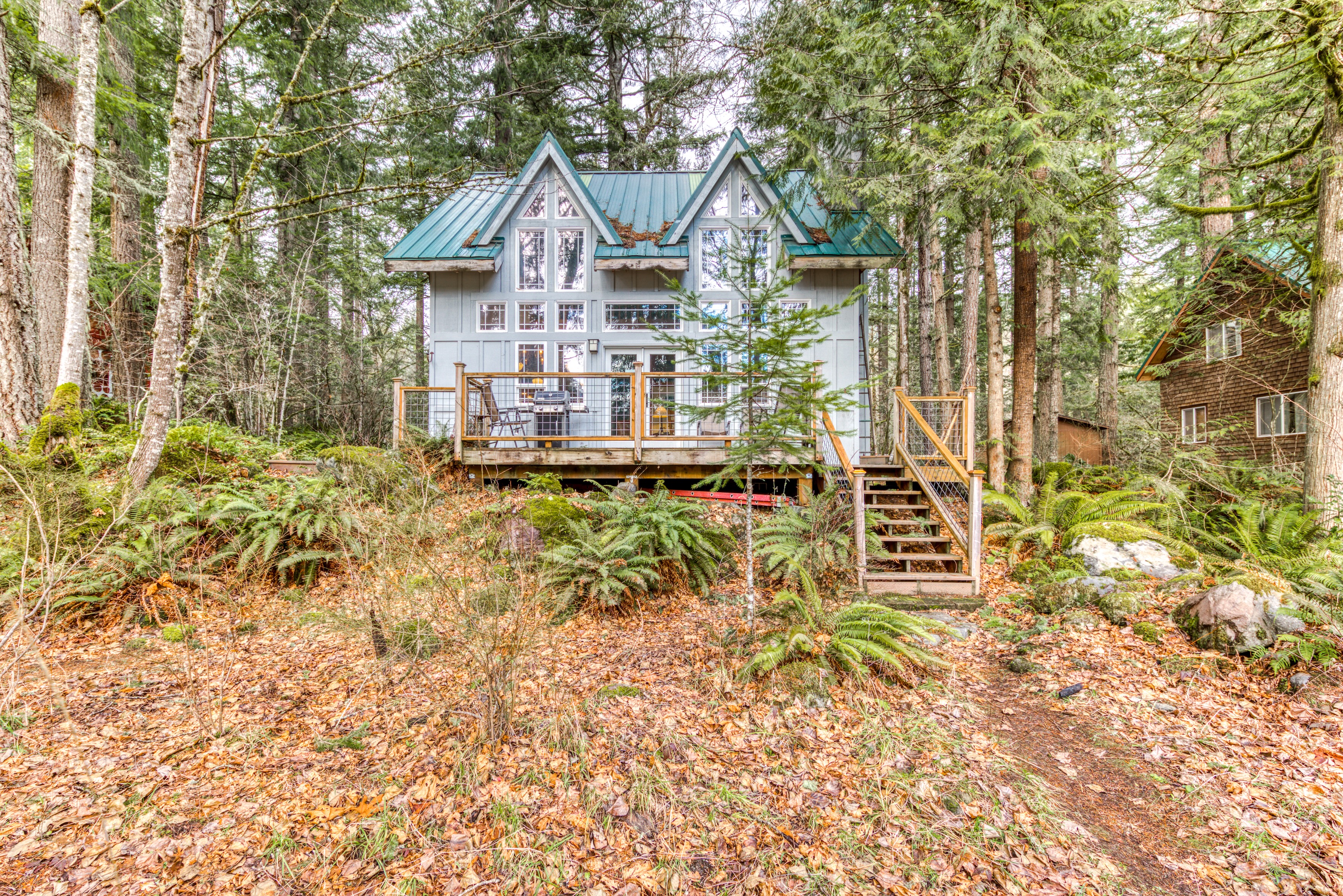 cabin on mount hood with green roof and wooden deck