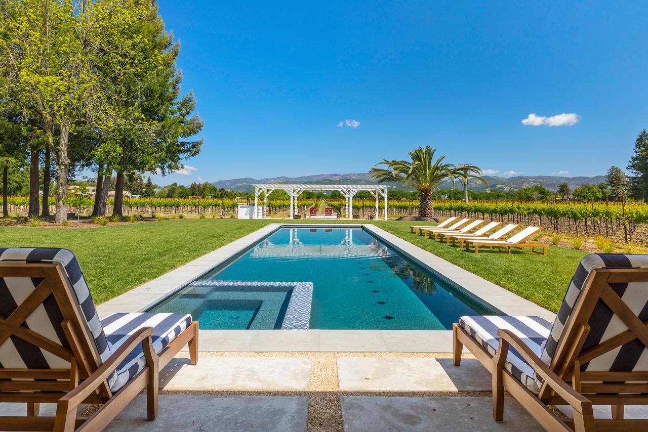 View from the pool overlooking a vineyard at a rental in Sonoma, CA.