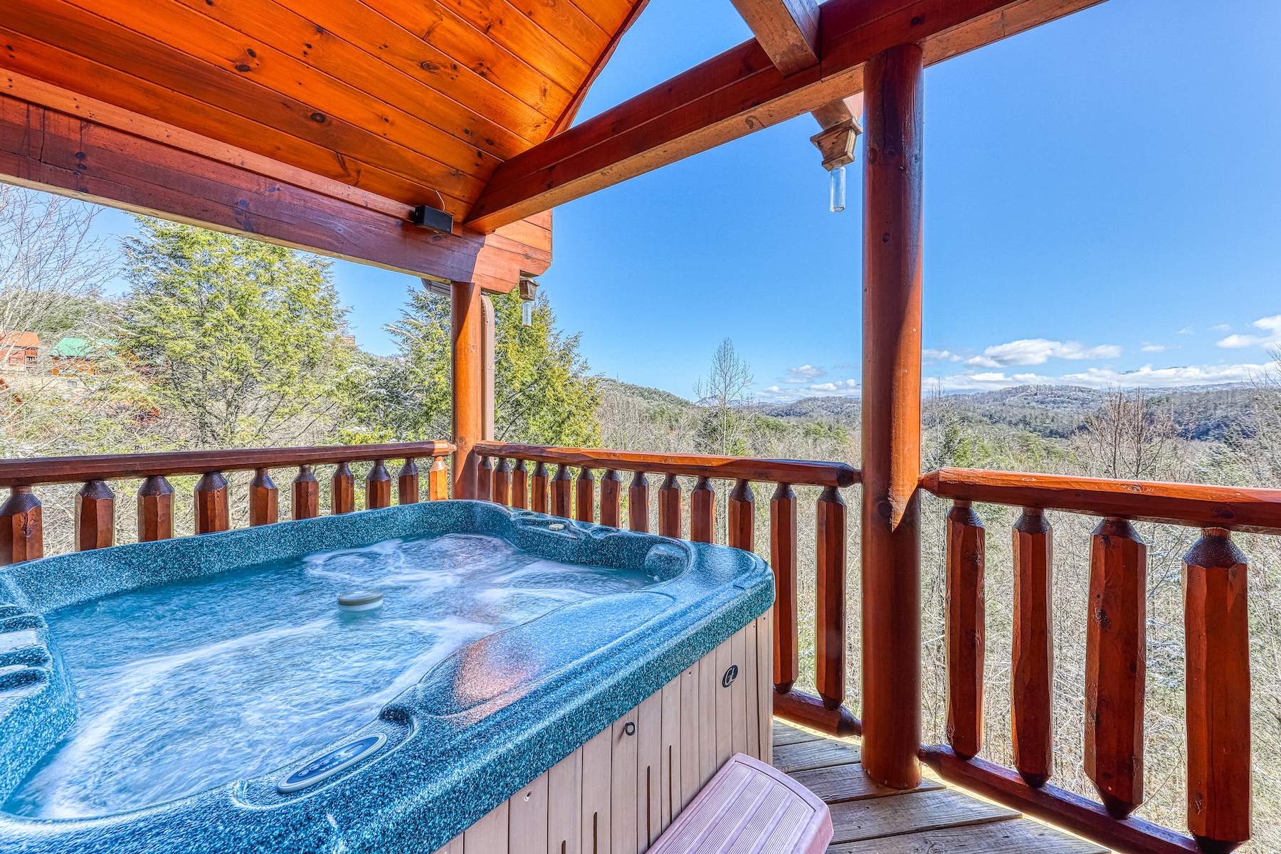 A vacation rental in Pigeon Forge, TN with a hot tub on the back patio overlooking the Smoky Mountains.
