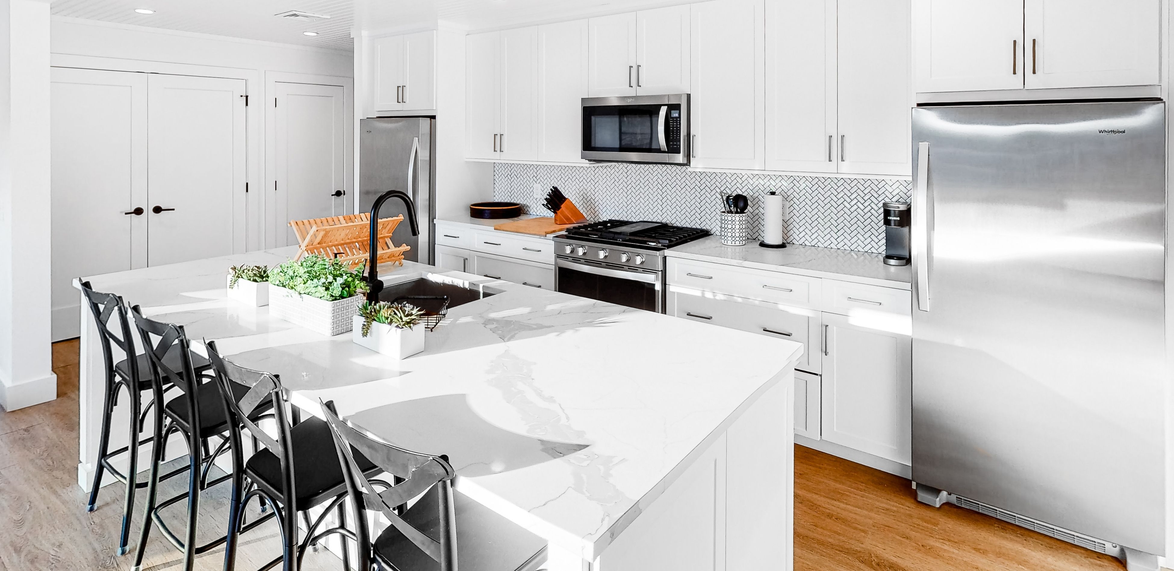 bright white kitchen with backsplash on fire island