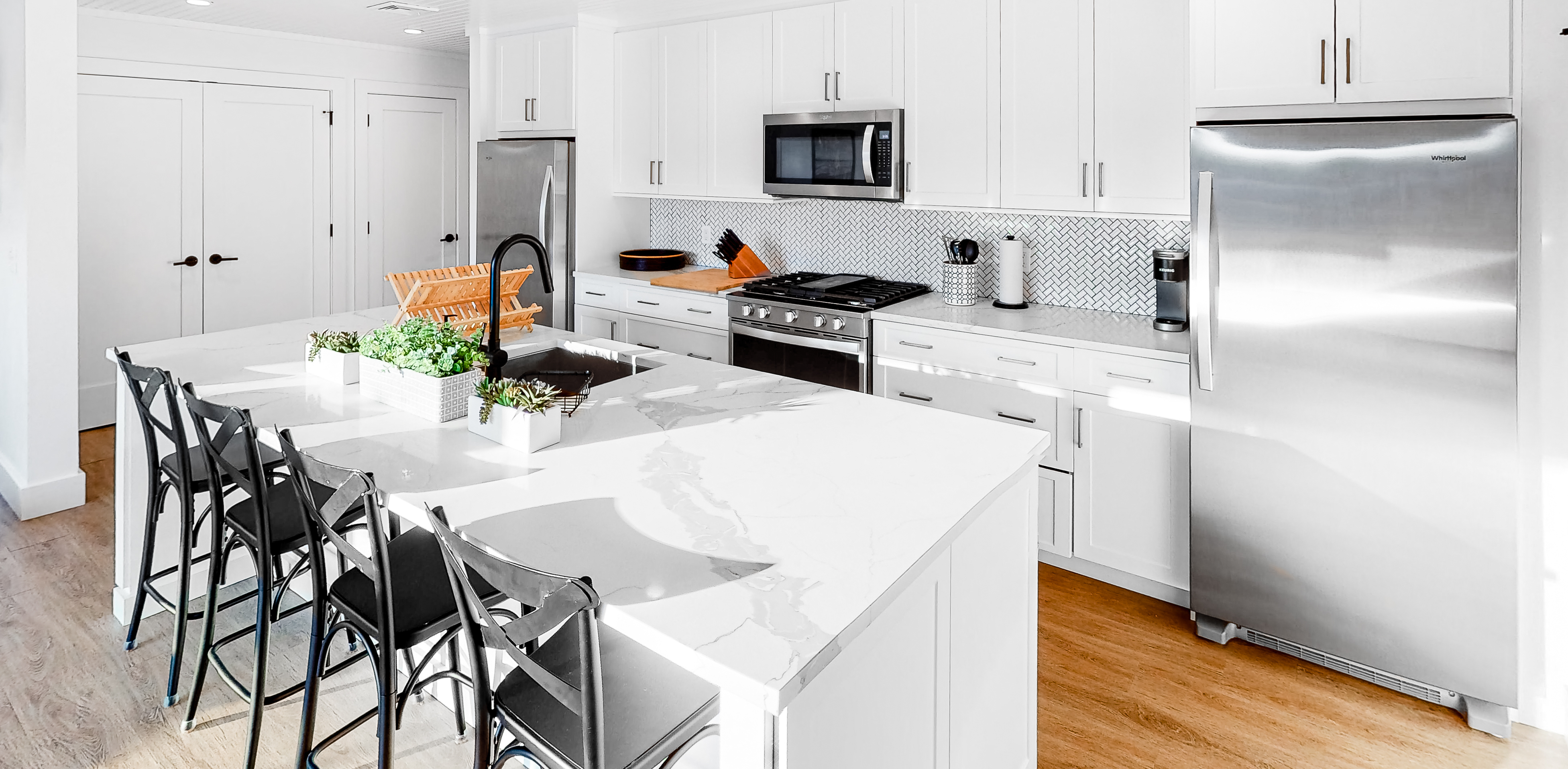 clean modern vacation rental kitchen with tile backsplash and stainless steel appliances in fire island, NY