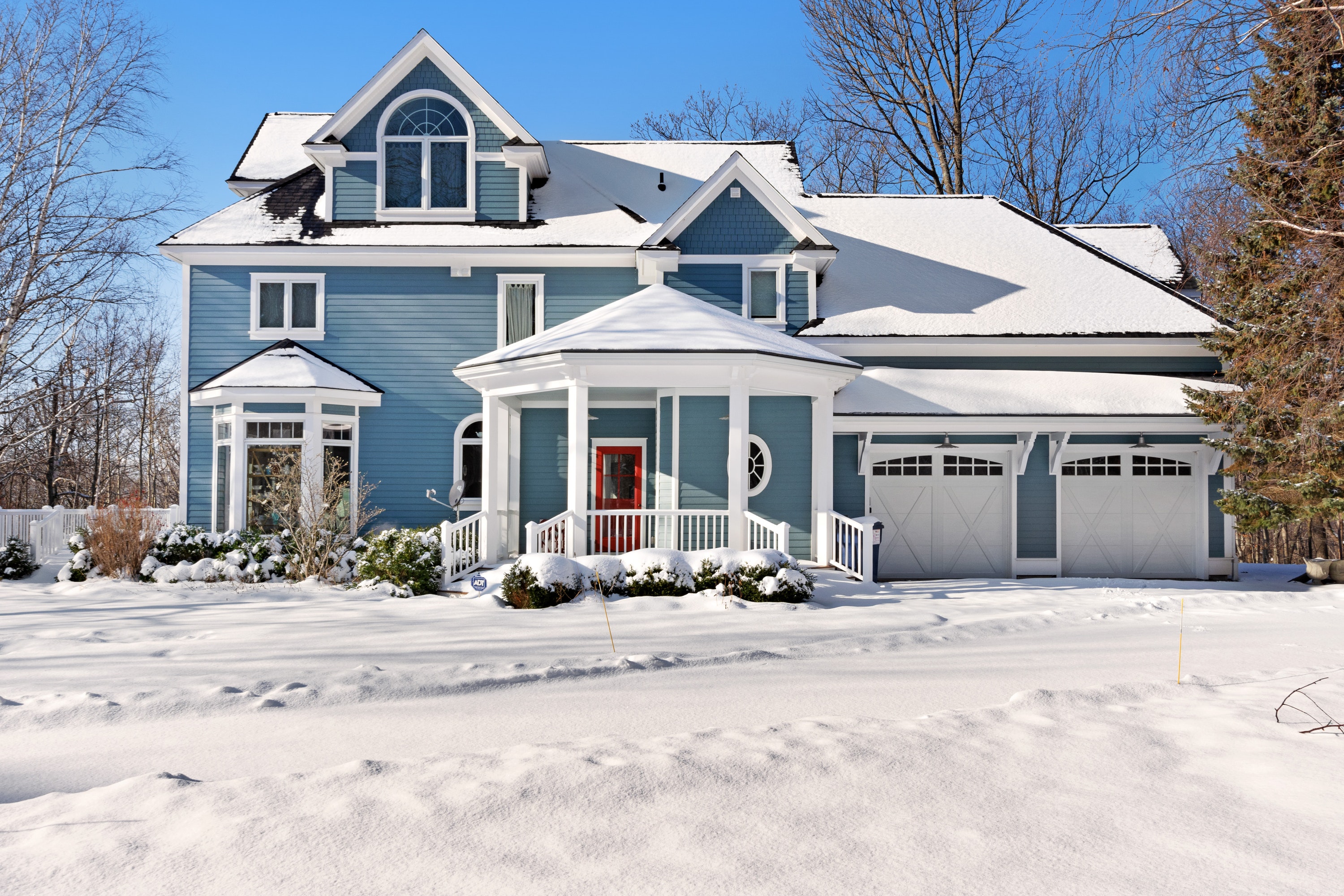two-story home in harbor springs, mi covered in a fresh layer of snow