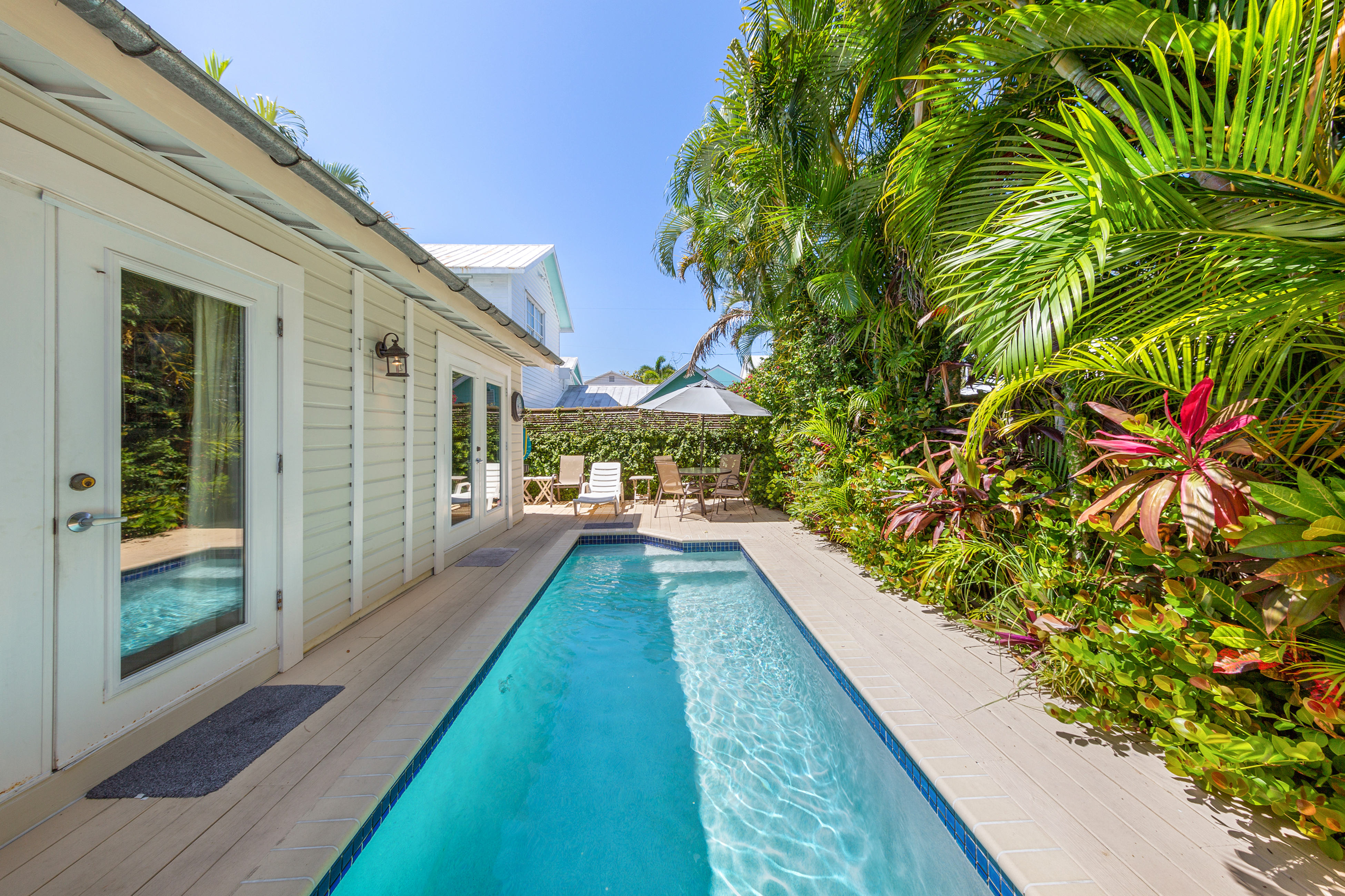 Long and straight outdoor pool in the backyard of a vacation rental in Key West, FL.