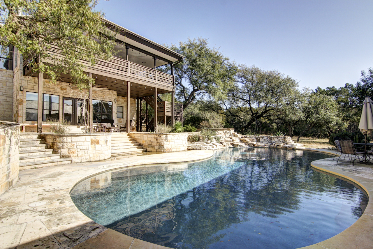 The pool area of a vacation rental with modern design in Austin, TX.