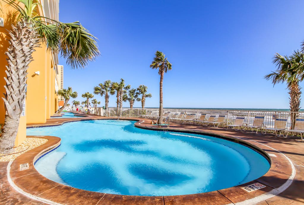 Splash Resort's beachfront outdoor pool surrounded by palm trees