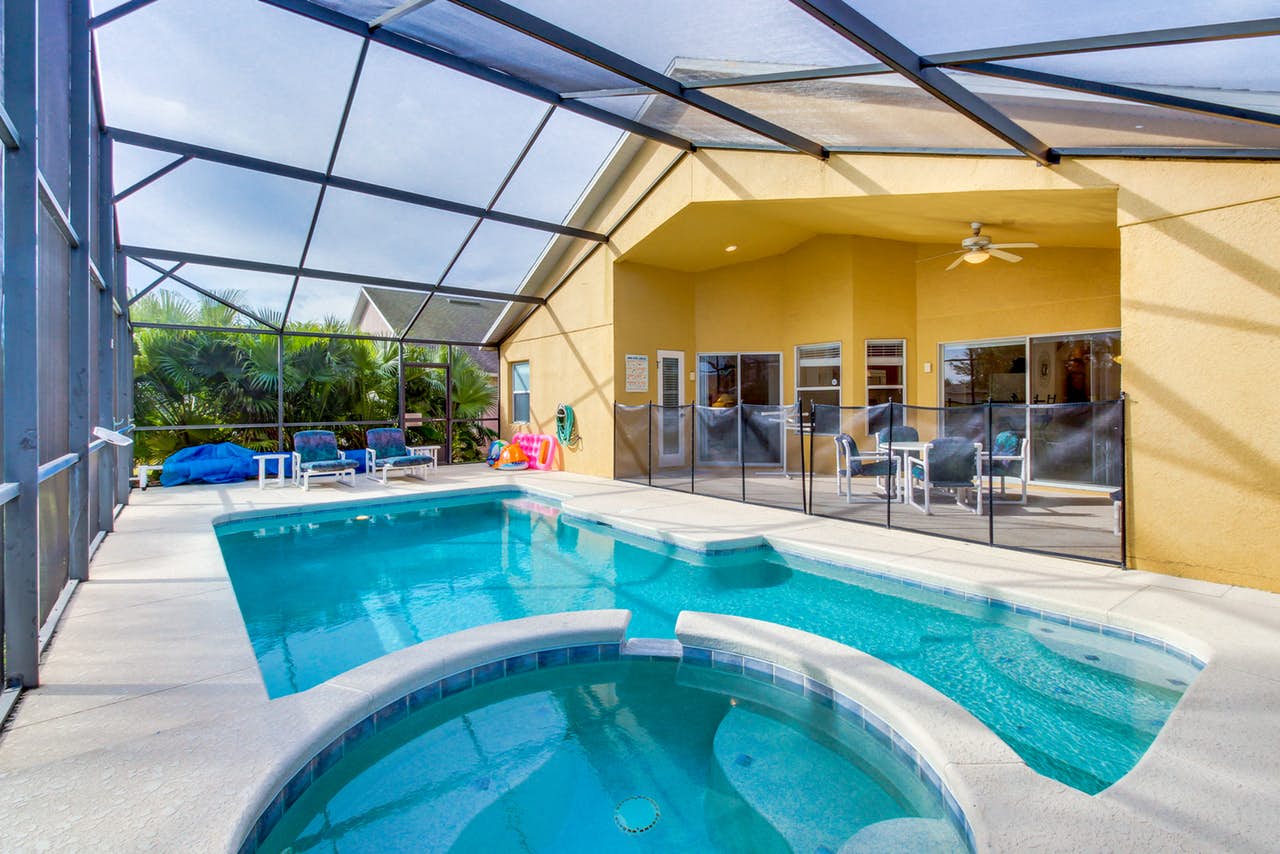 Enclosed pool with patio furniture in Davenport, FL