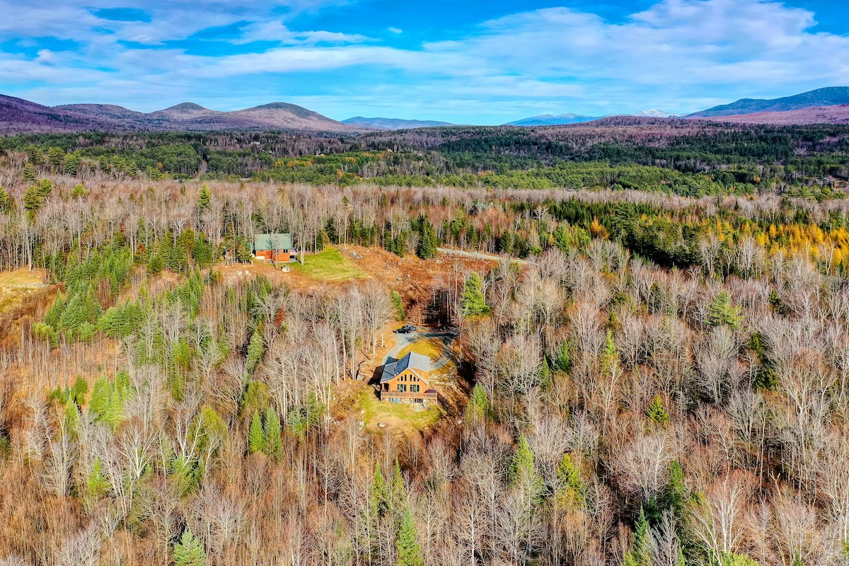 Drone shot of a landscape in the fall with cabins.
