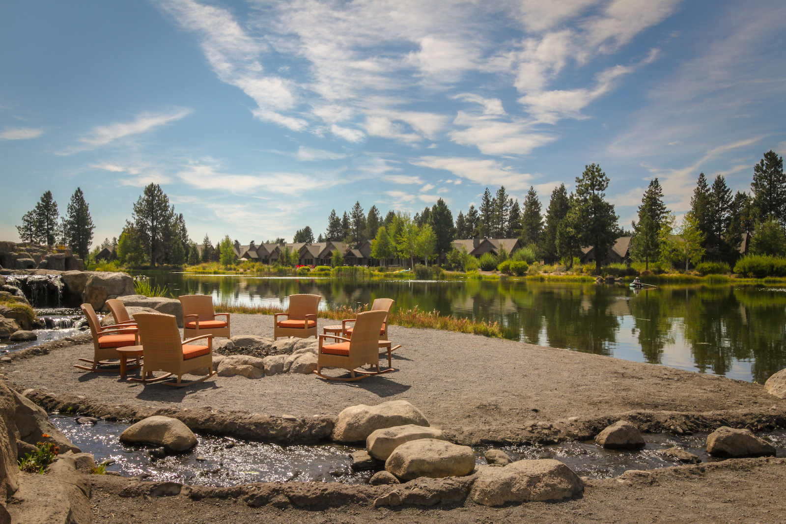 Chairs surrounding a firepit on the Deschutes River at a vacation rental in Sun River, Oregon.