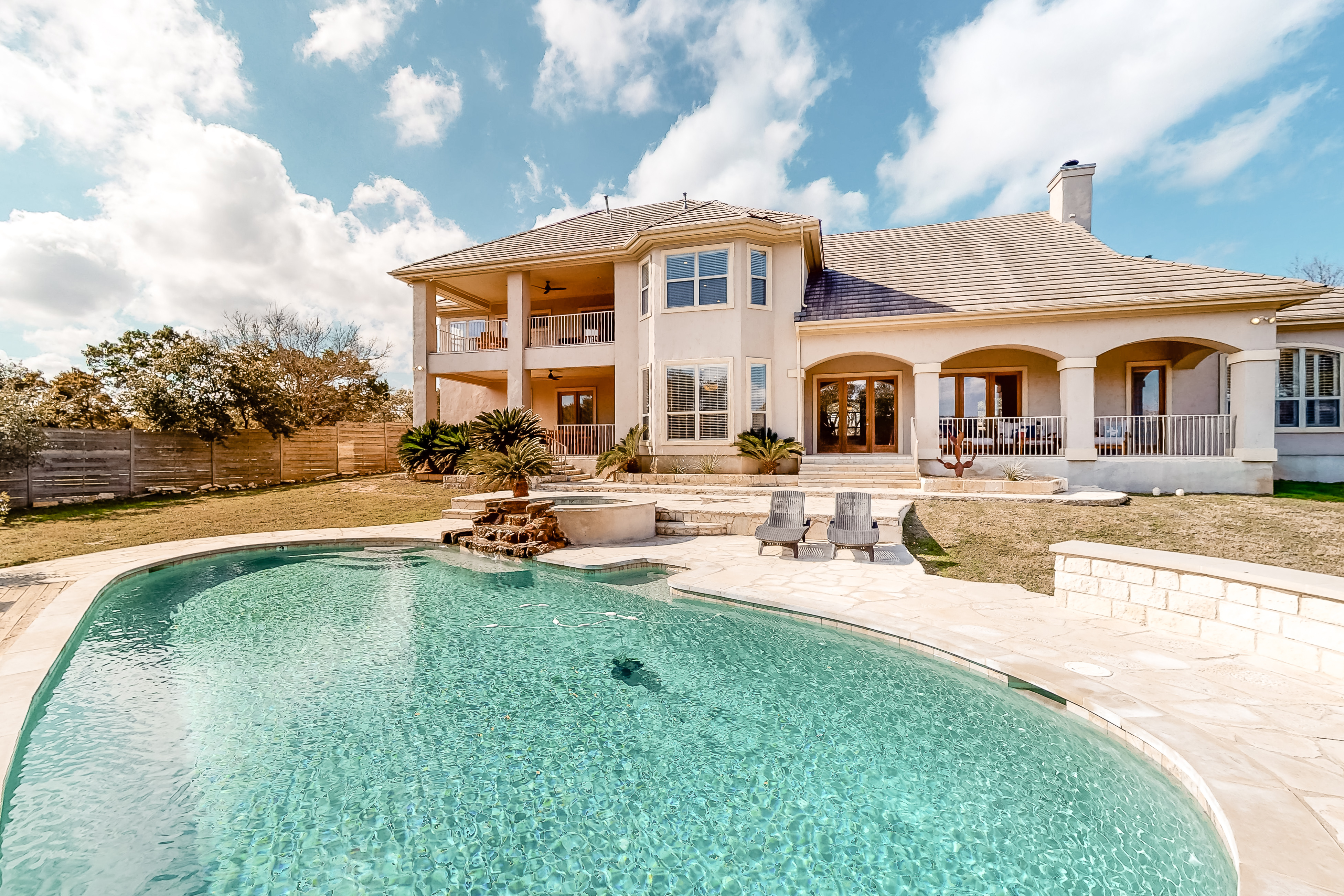 A grand vacation home rental in Spicewood, TX with an outdoor pool.