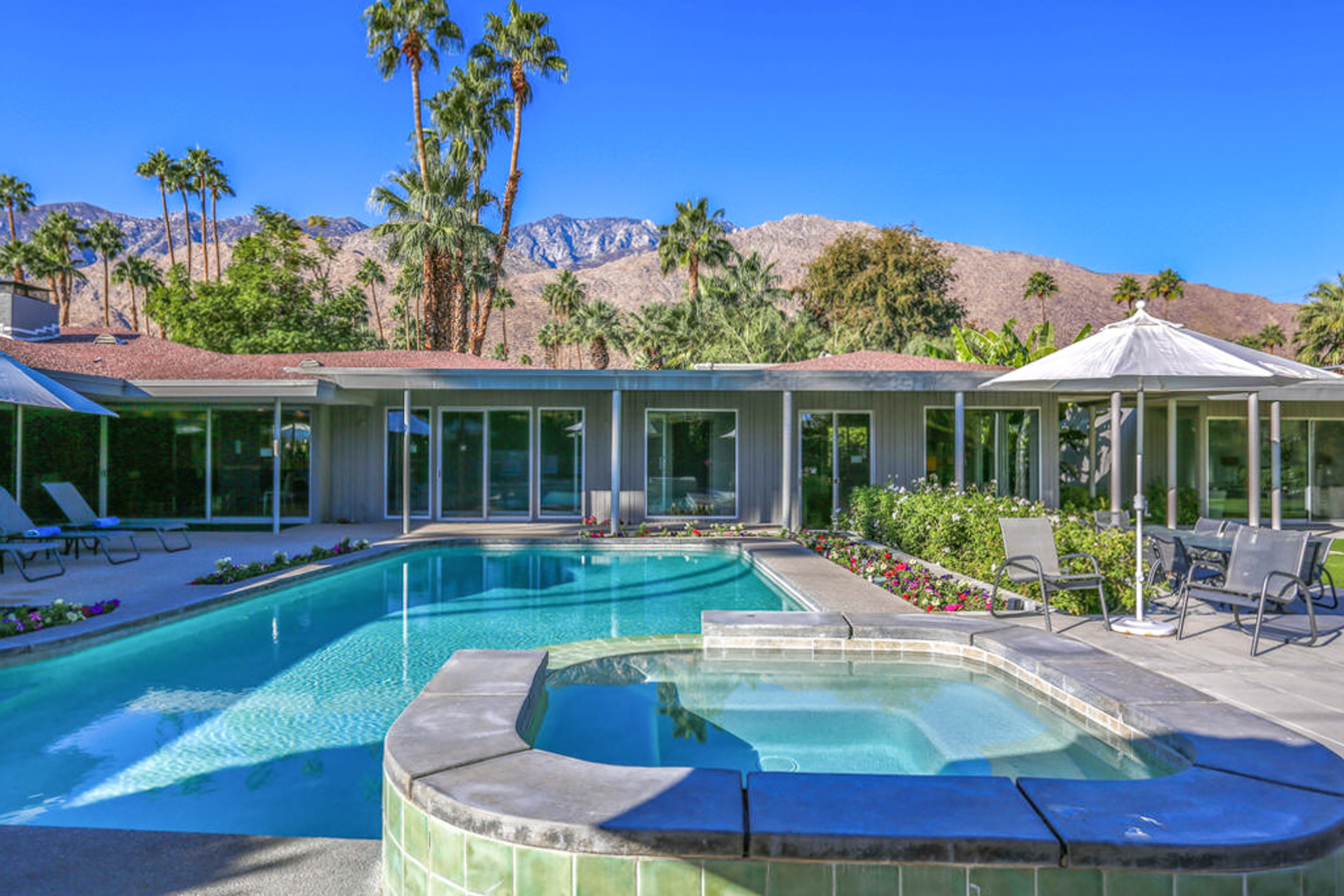 outdoor pool and hot tub of palm springs home with mountain views