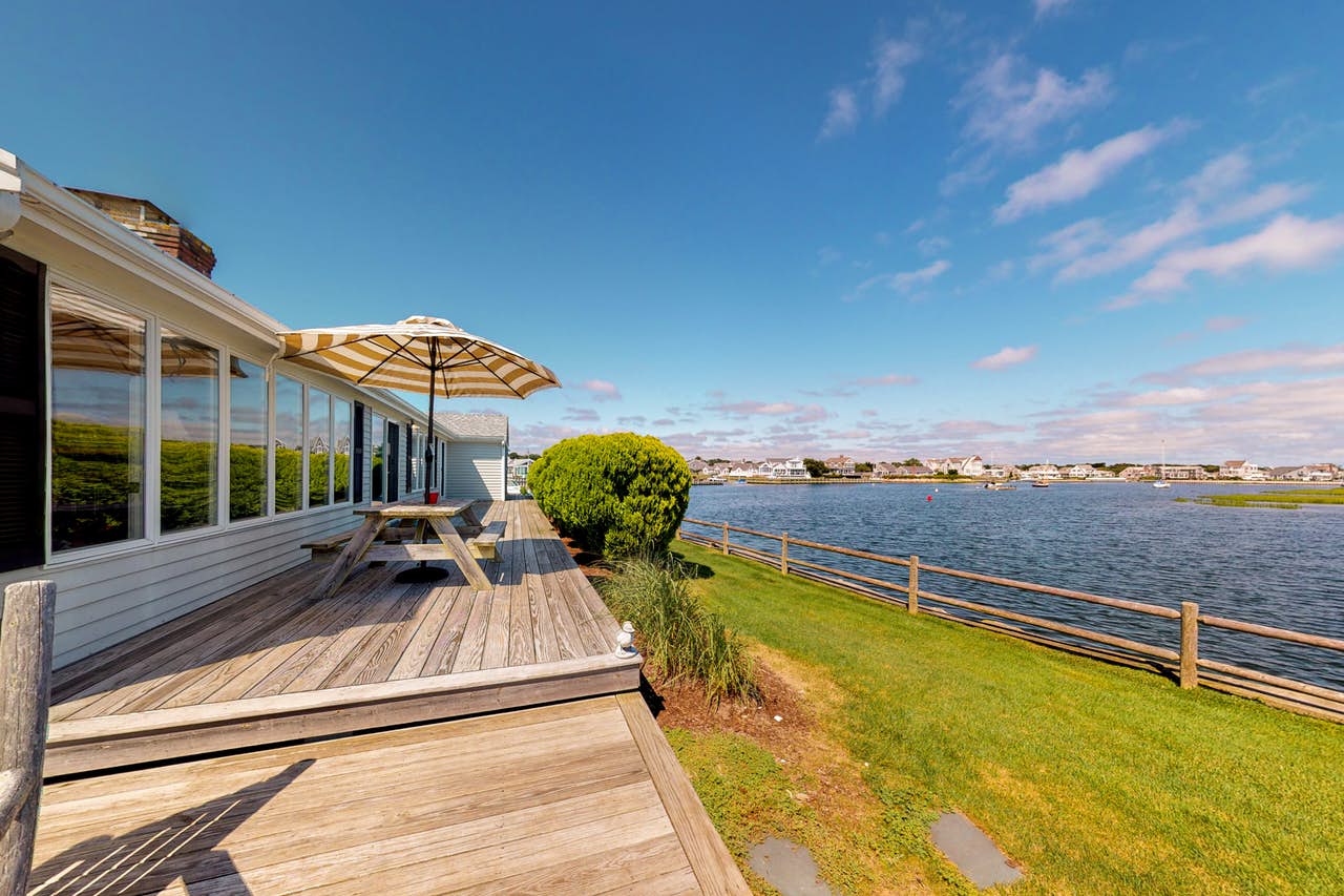 Cape Cod waterfront vacation rental back deck with view of the water