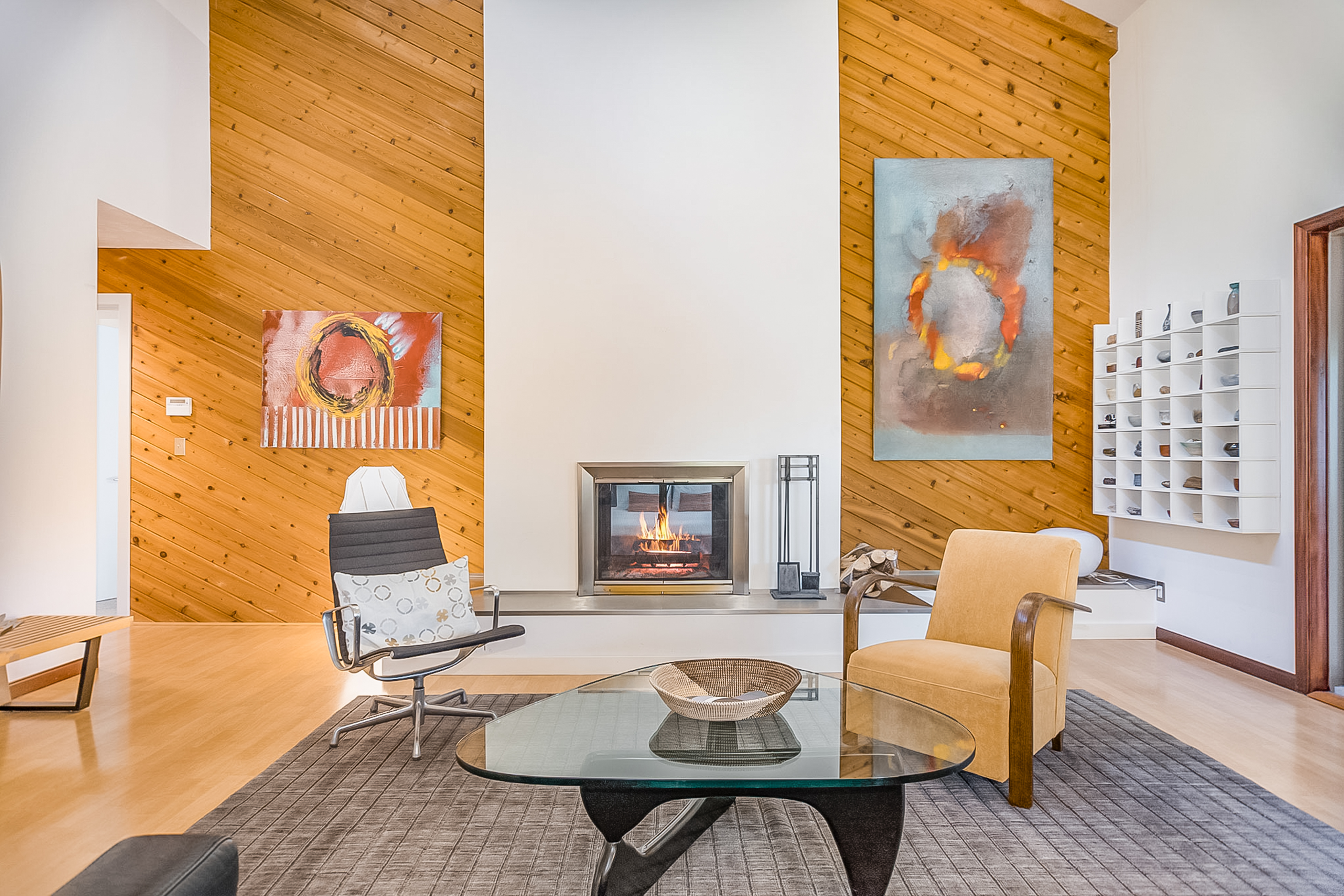 modern wood paneled walls surround a gas fireplace