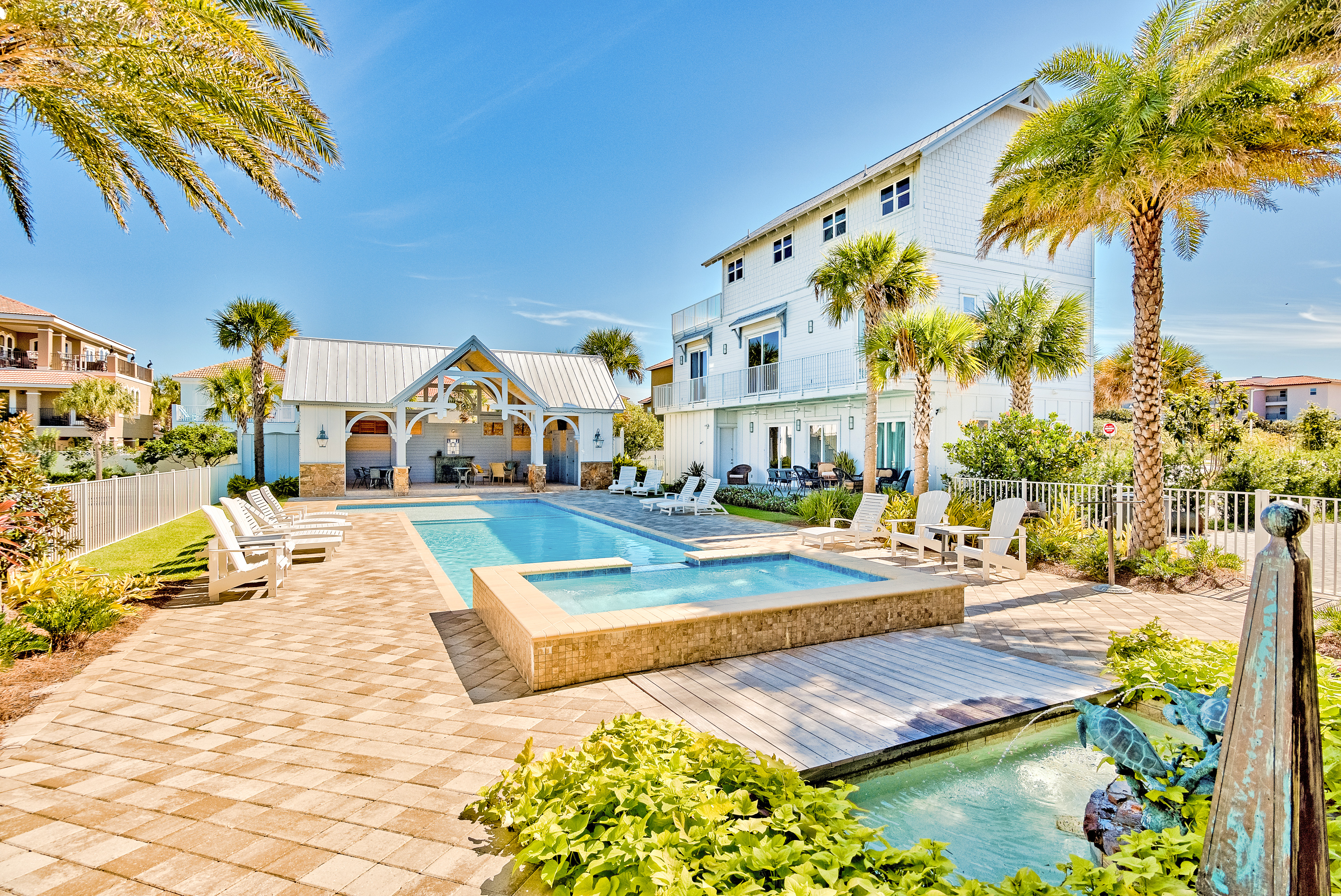Vacation rental in Miramar Beach, FL with outdoor pool and plenty of chairs for sunbathing