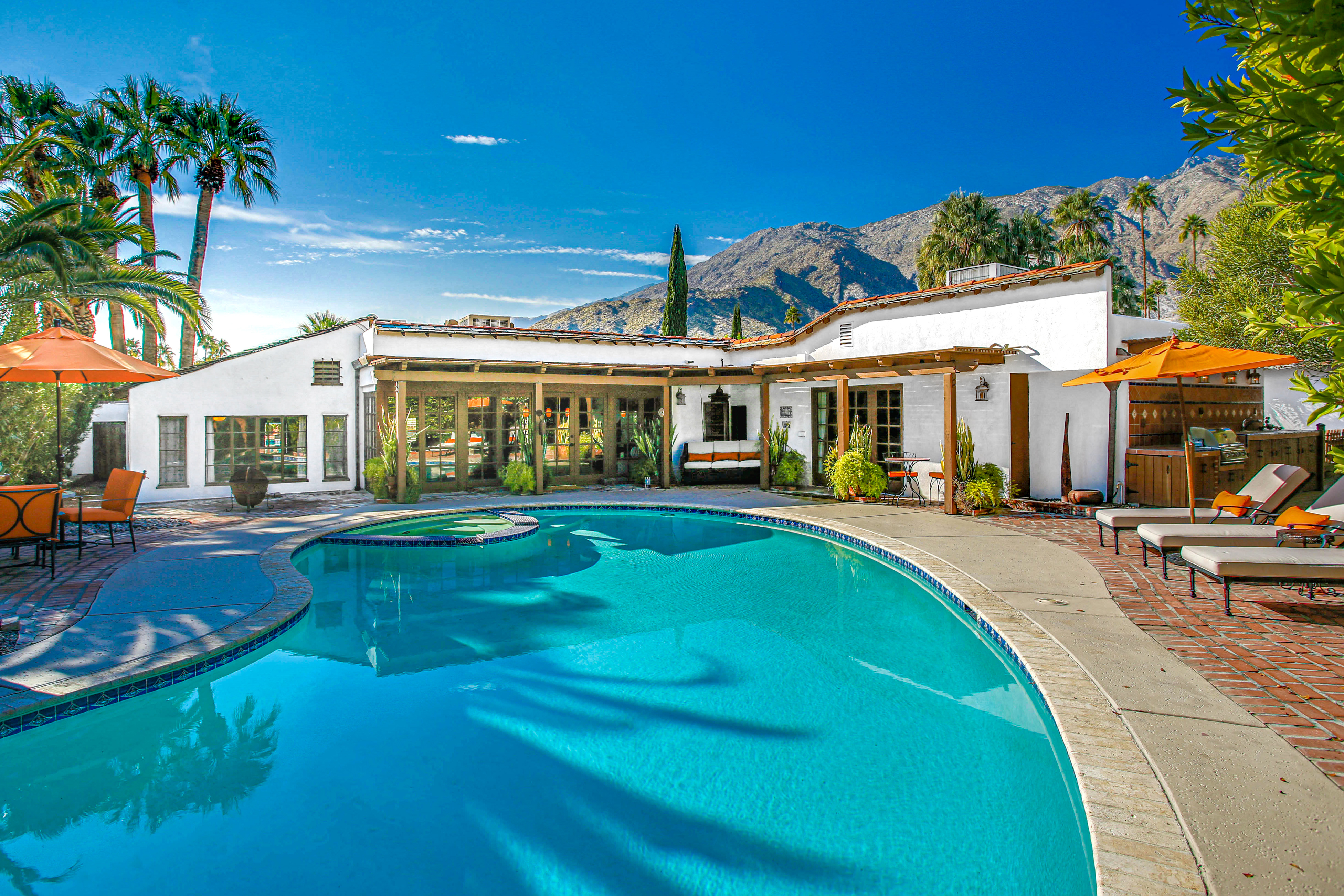 white home in palm springs with outdoor pool and mountain views