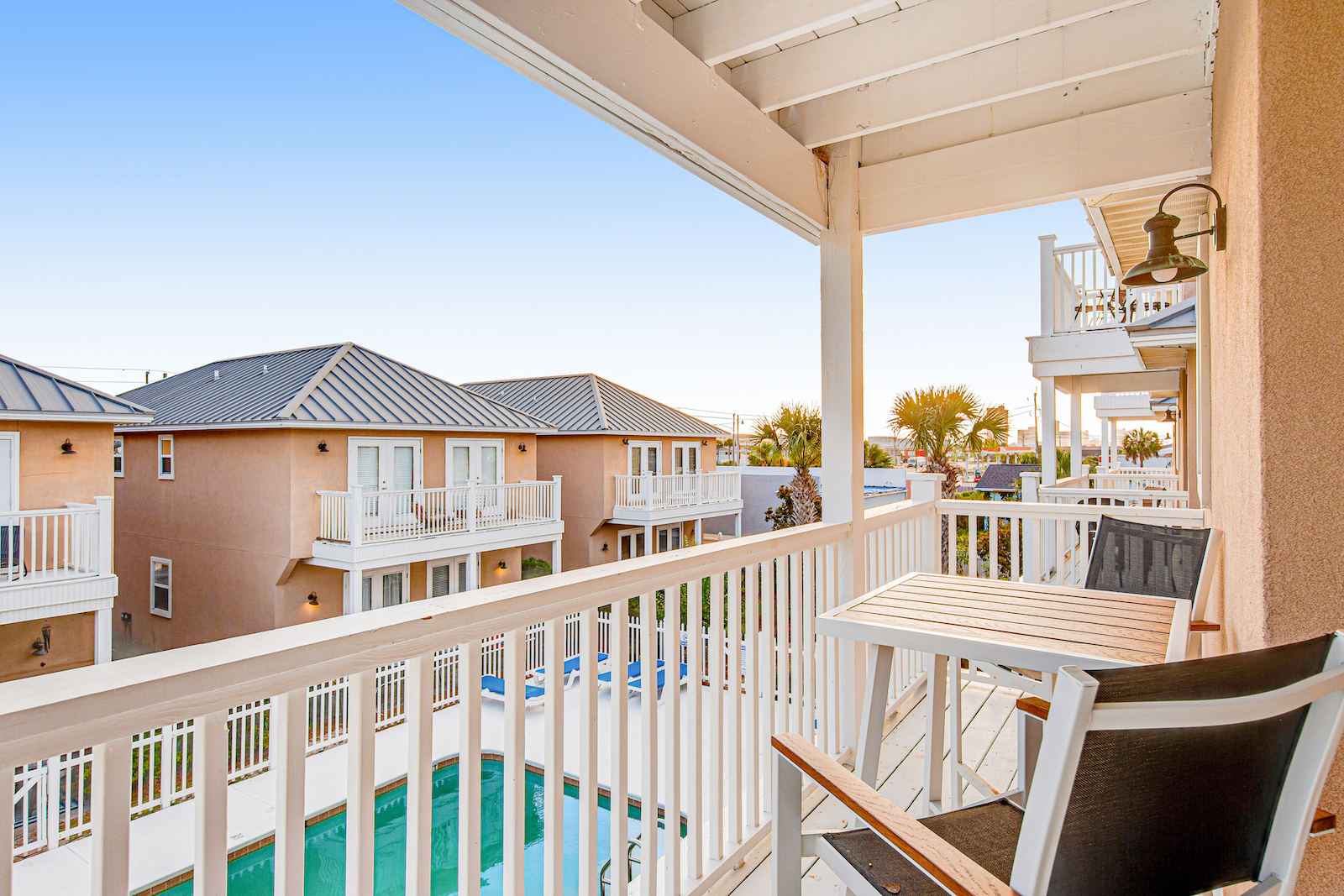 The outdoor deck overlooking a pool in a Panama City Beach vacation rental.