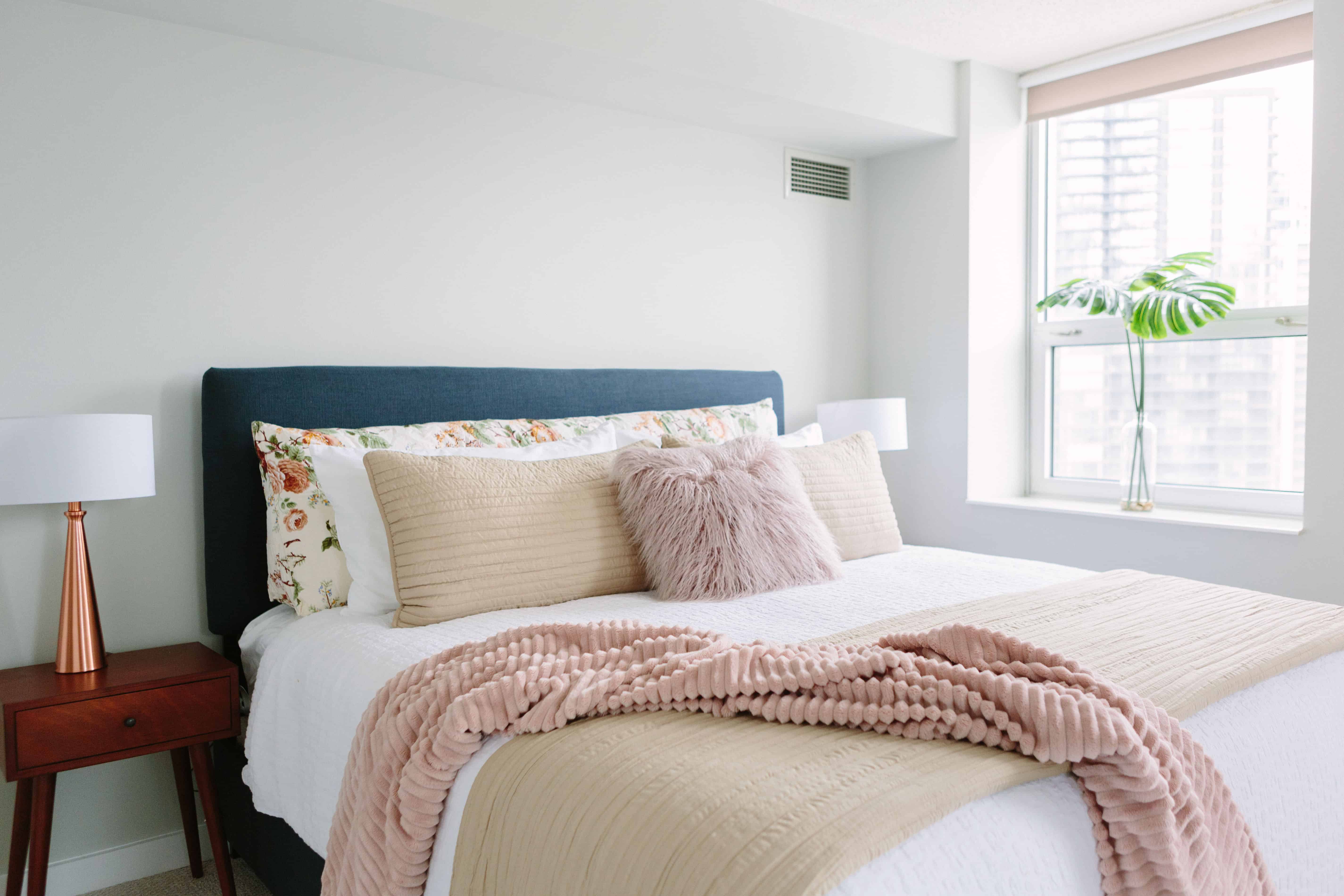 A bed made by a professional housekeeper in a vacation home