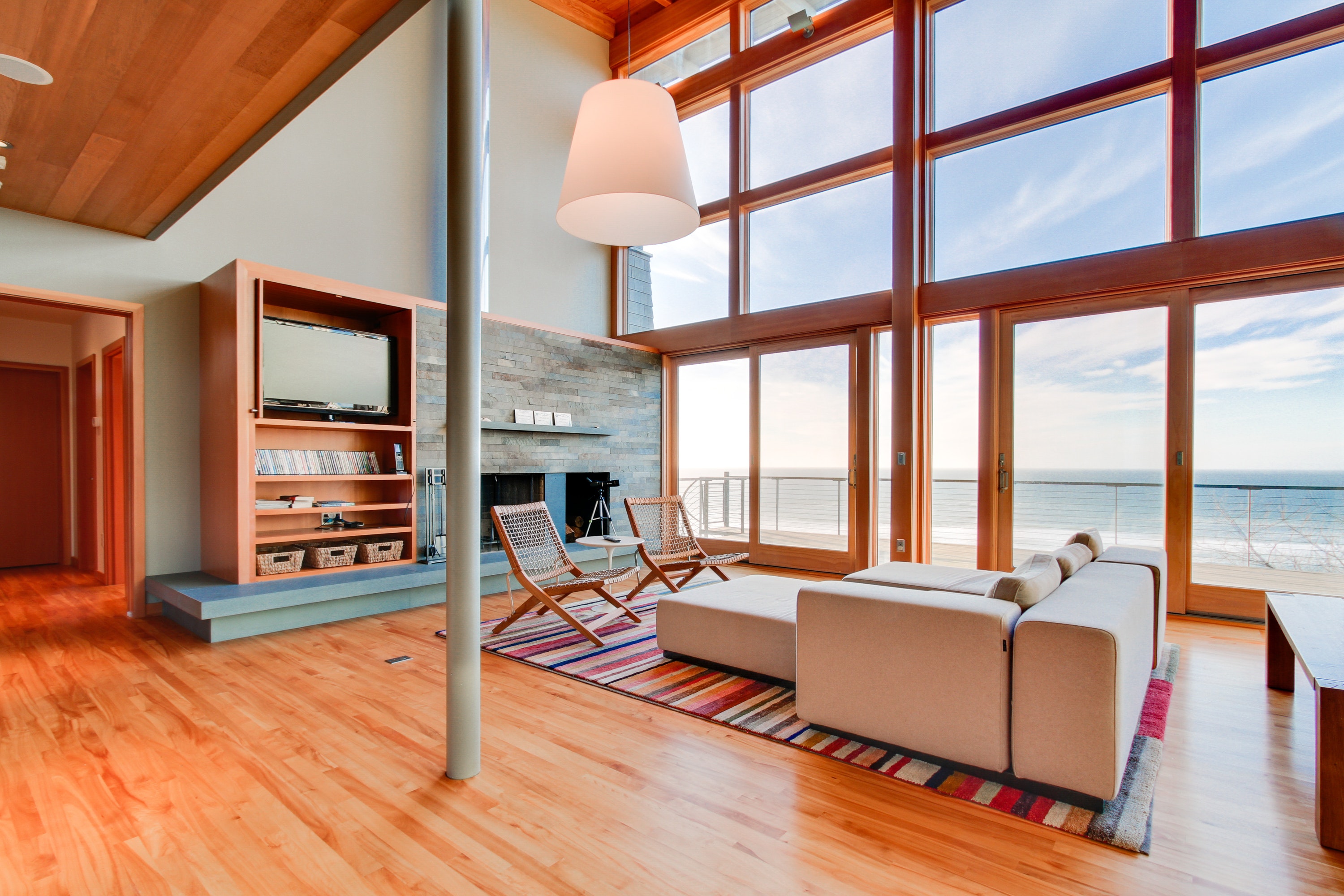 wood-burning fireplace accented by minimalist design and ocean views