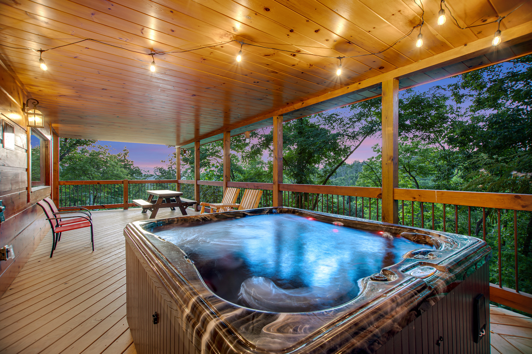 The deck of a vacation rental with a hot tub in Gatlinburg, TN
