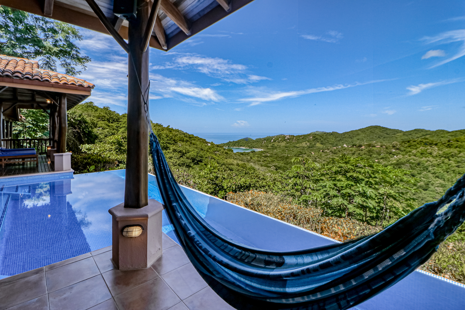 Hammock overlooking a pool and a stunning view at a vacation rental in Punta Islita, Costa Rica.