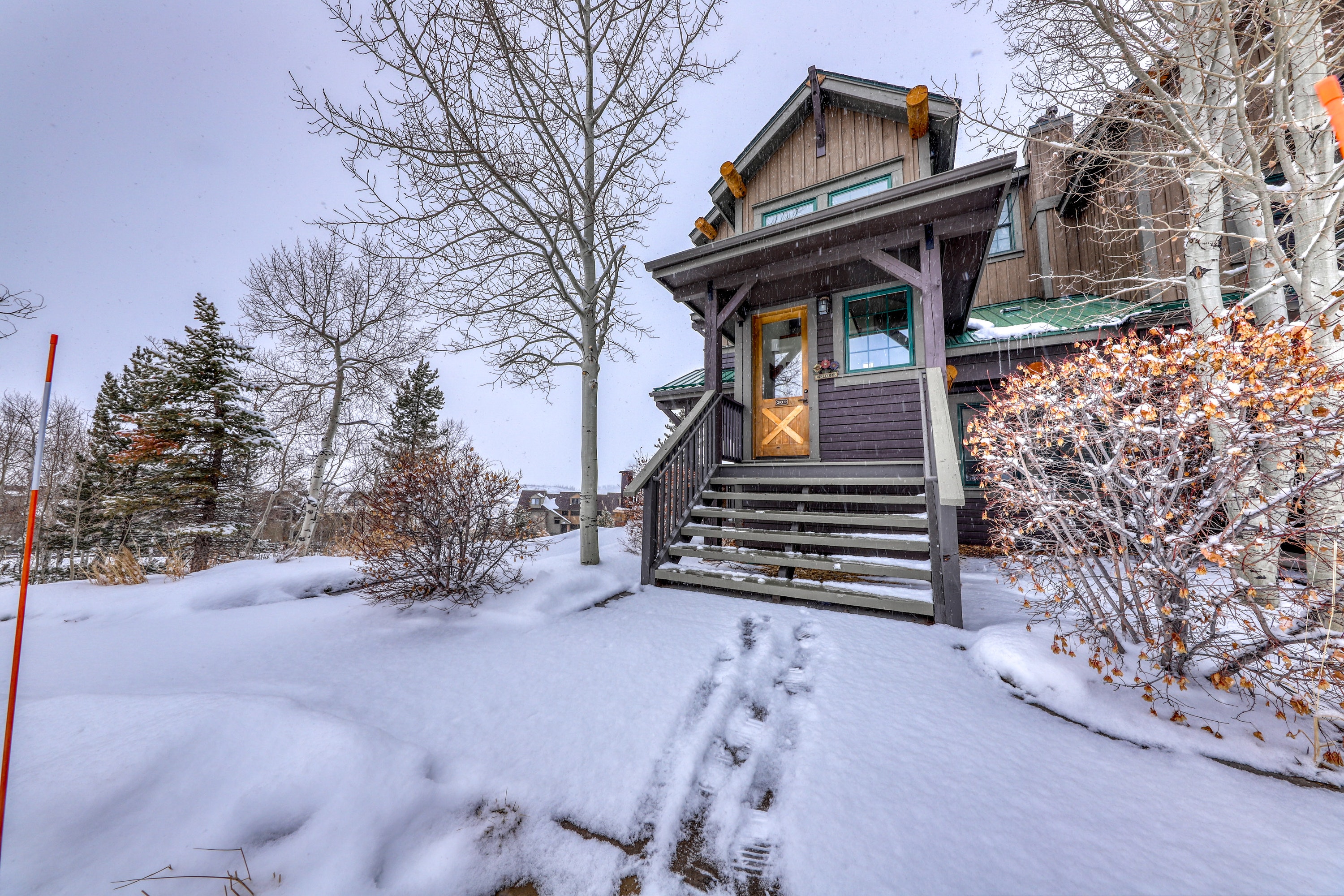 adorable cabin covered in snow in Granby, CO