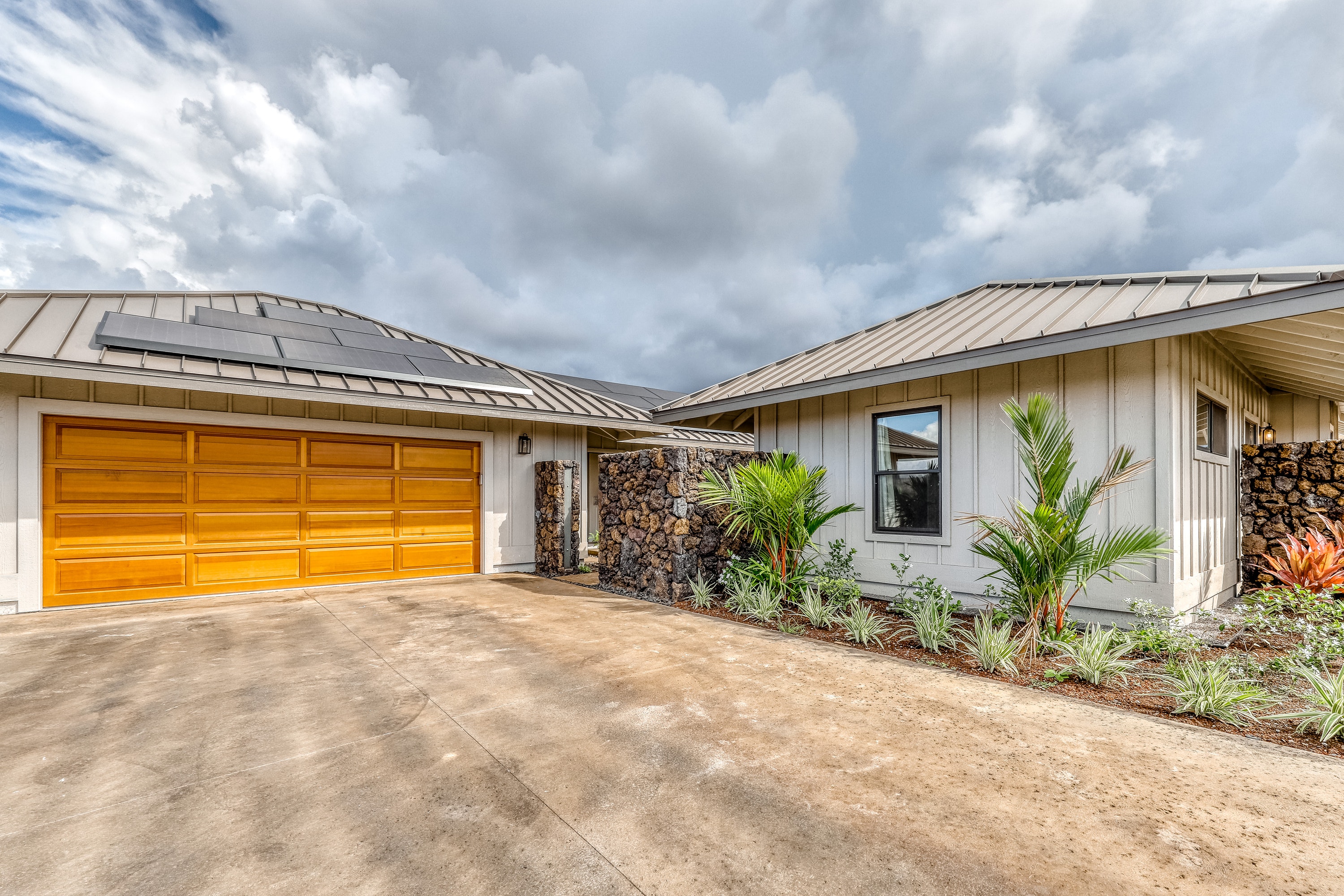 family home with attached garage and beautiful landscaping in Waikoloa, HI
