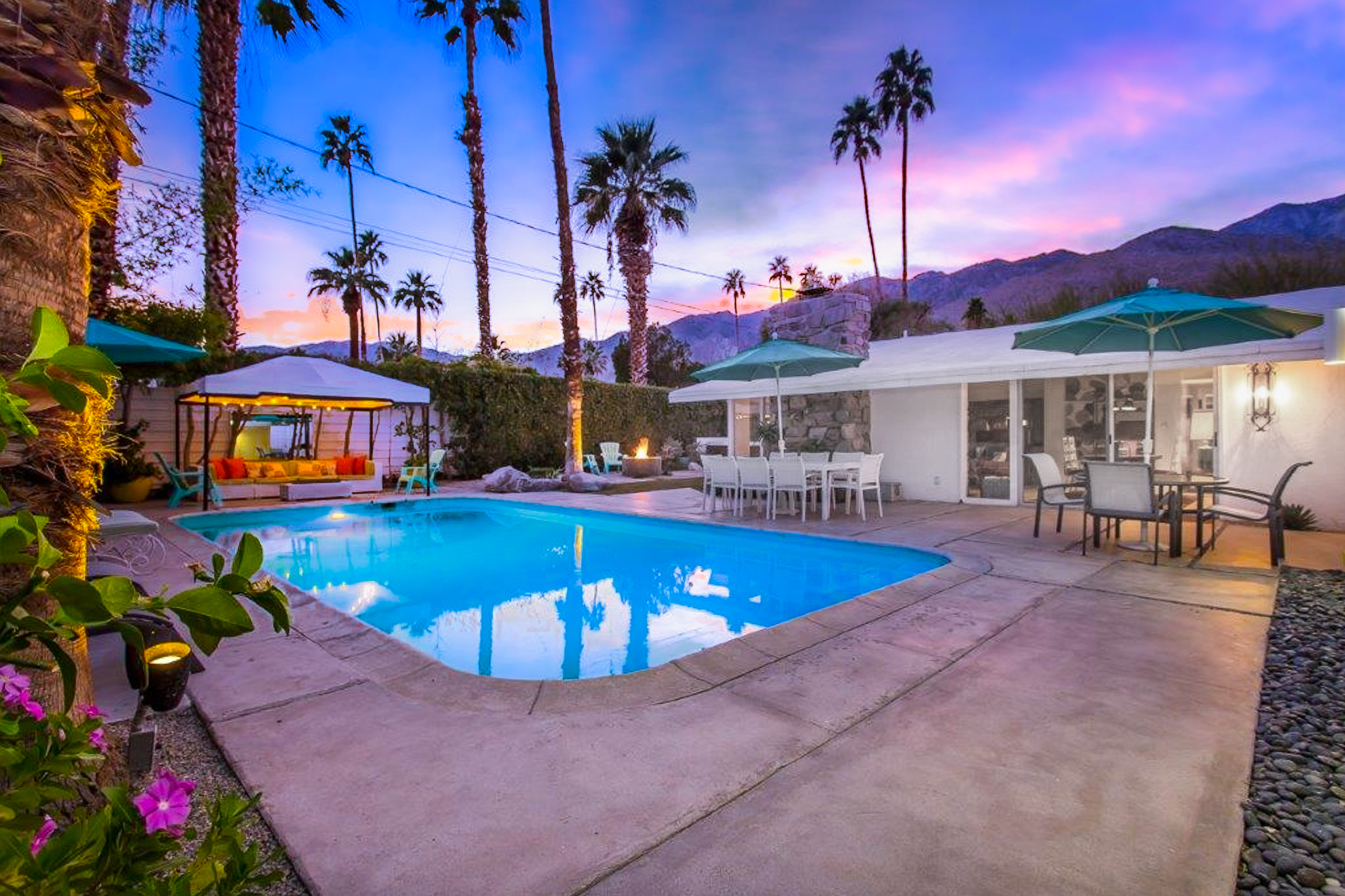 The backyard of a family friendly vacation rental in Palm Springs, California with a pool.