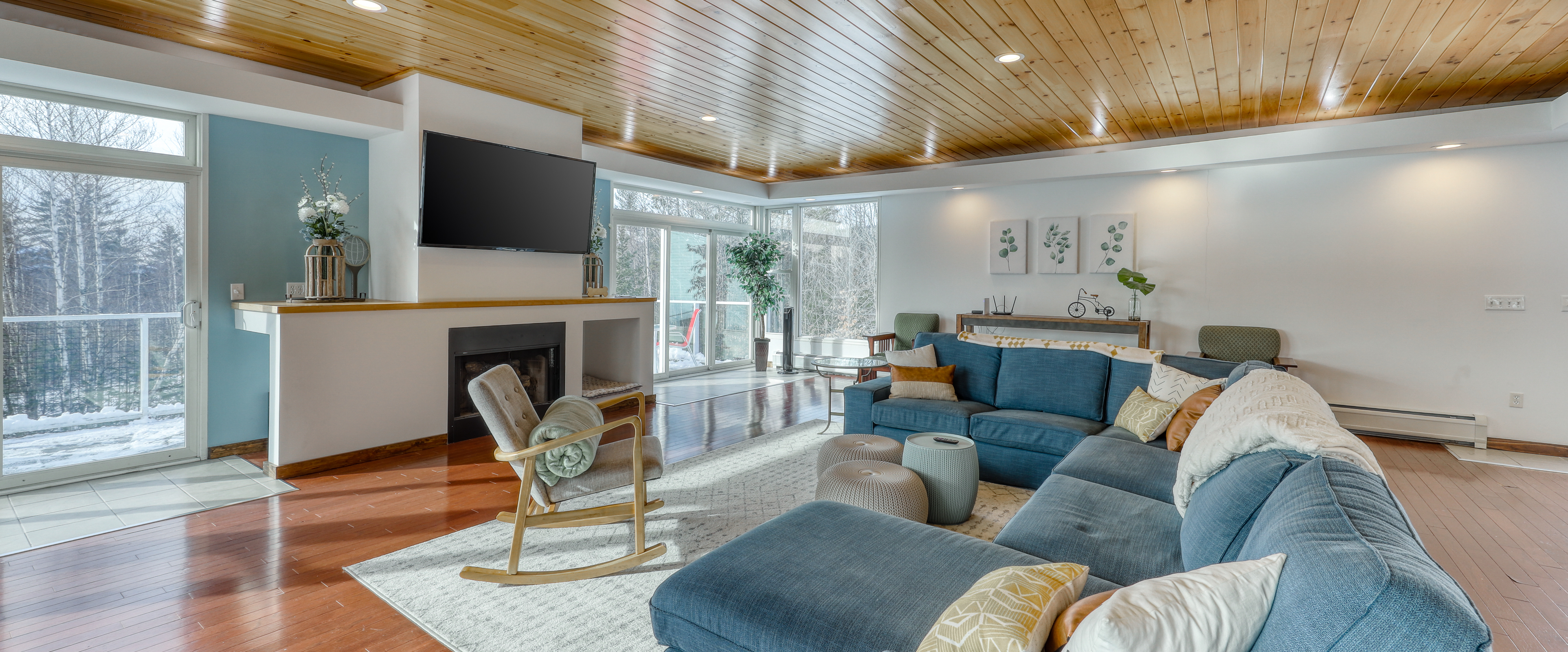 Living room with blue hues inside of Bethel, ME vacation home