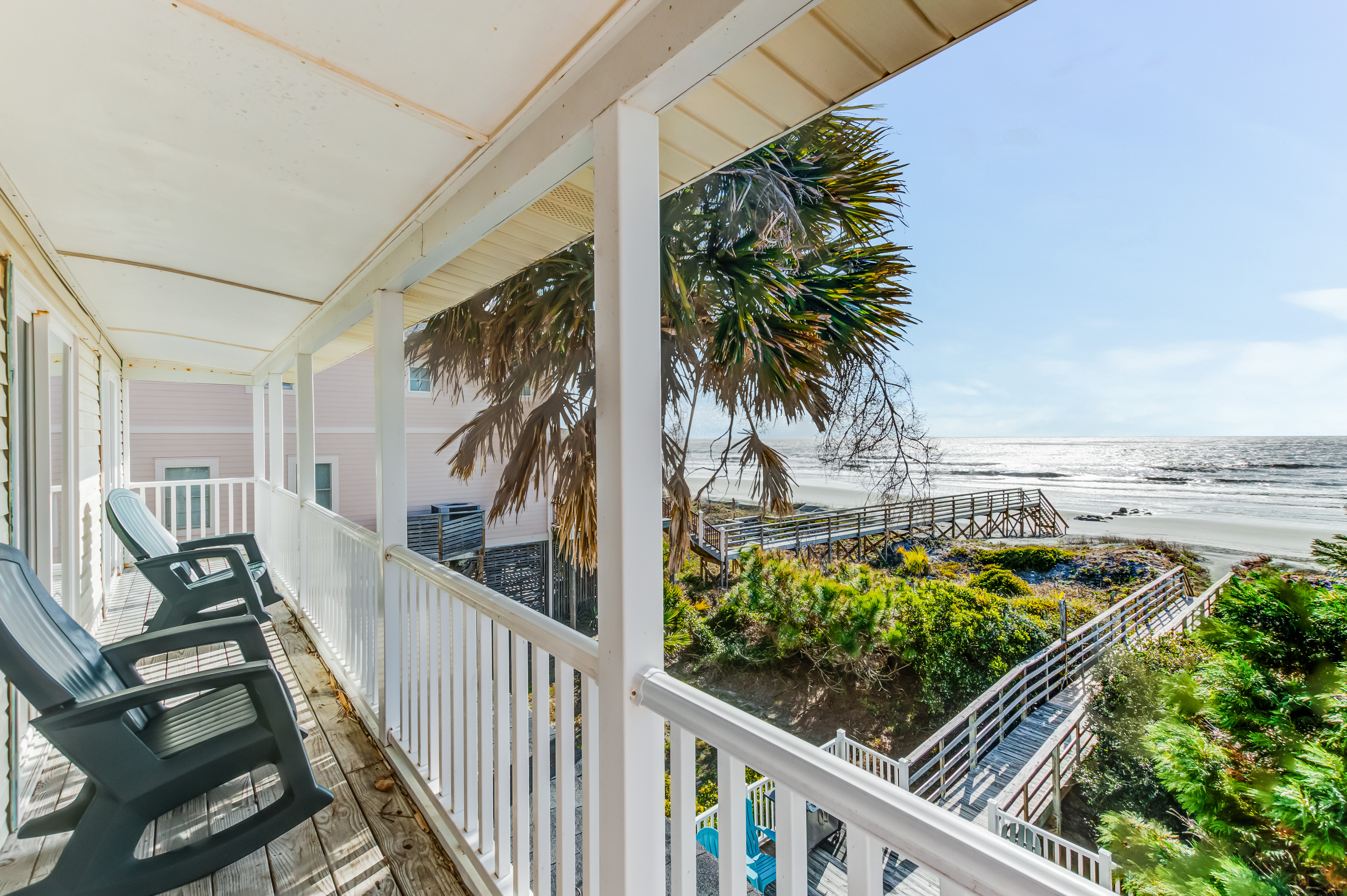 Outdoor back deck of a vacation rental in Folly Beach, SC facing towards the shore.