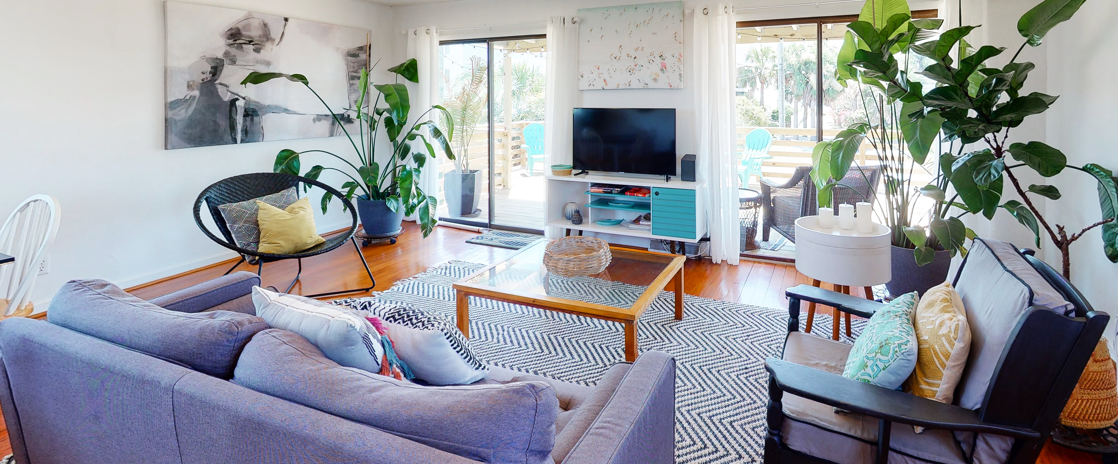 living room of folly beach vacation rental with large live plants