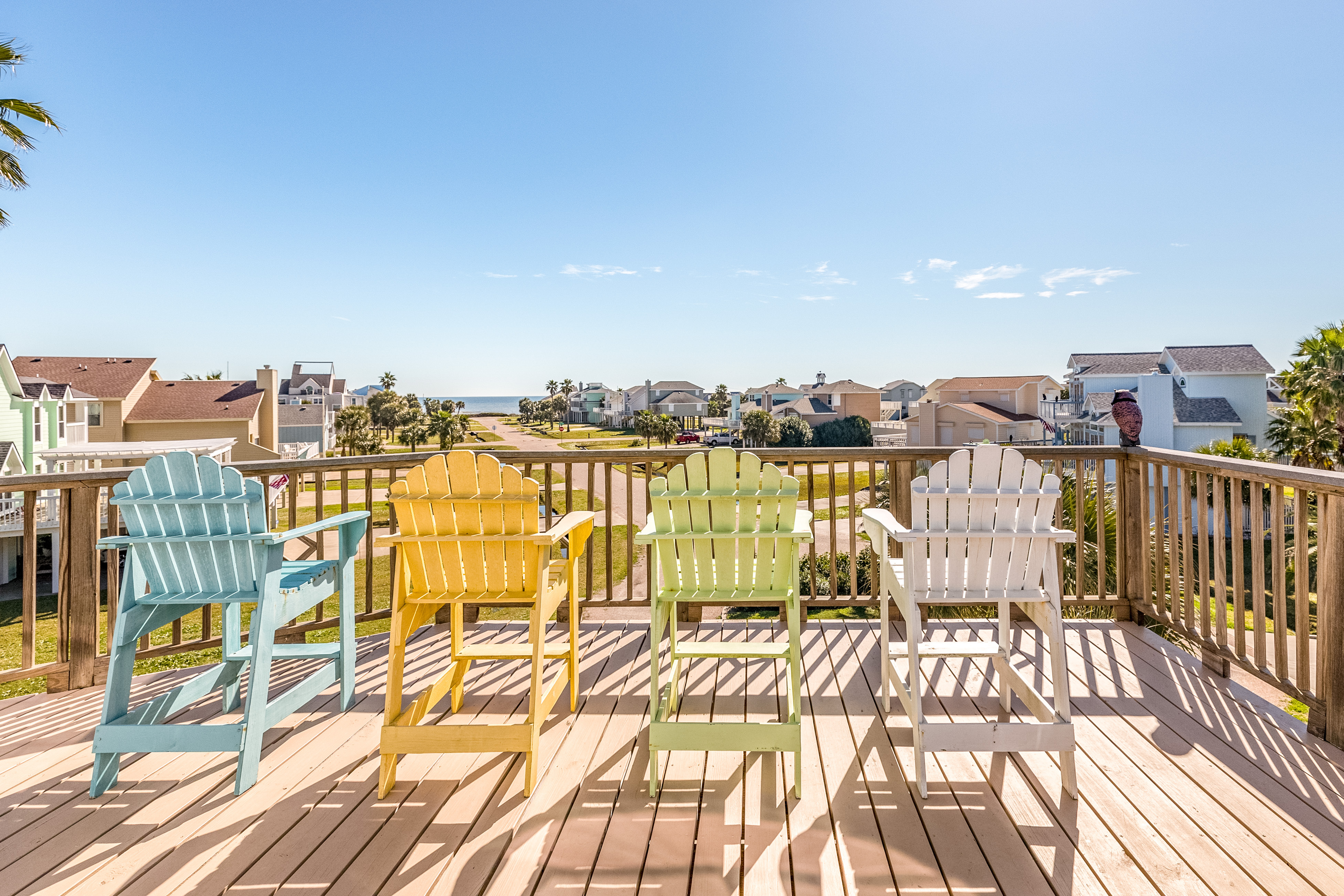 Colorful chairs sit on deck of gulf view vacation home in Galveston, TX
